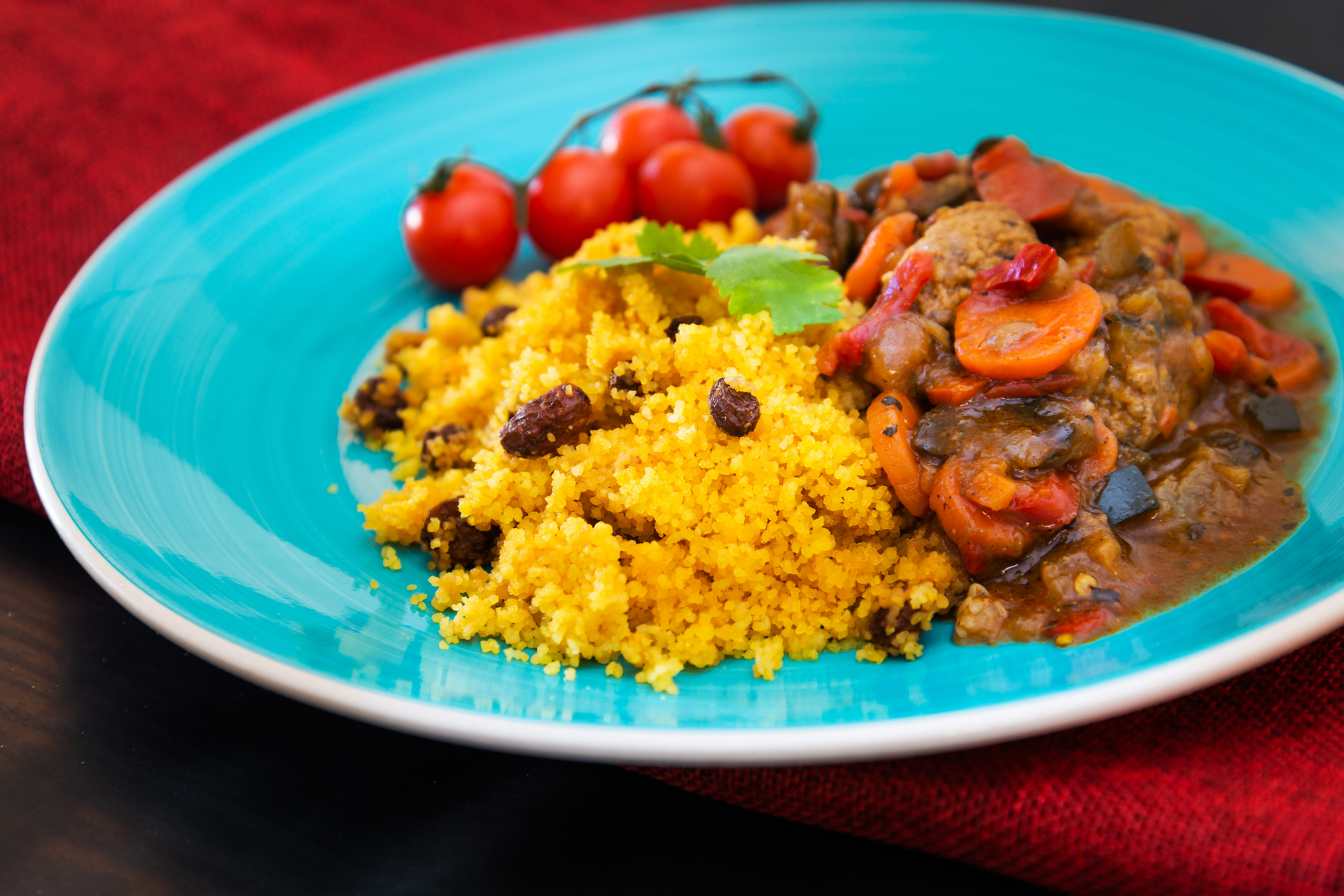 Overhead flat-lay of all ingredients for Senegalese Mafé Gertie with Millet Couscous and Spinach Sauce laid out on a kitchen surface.