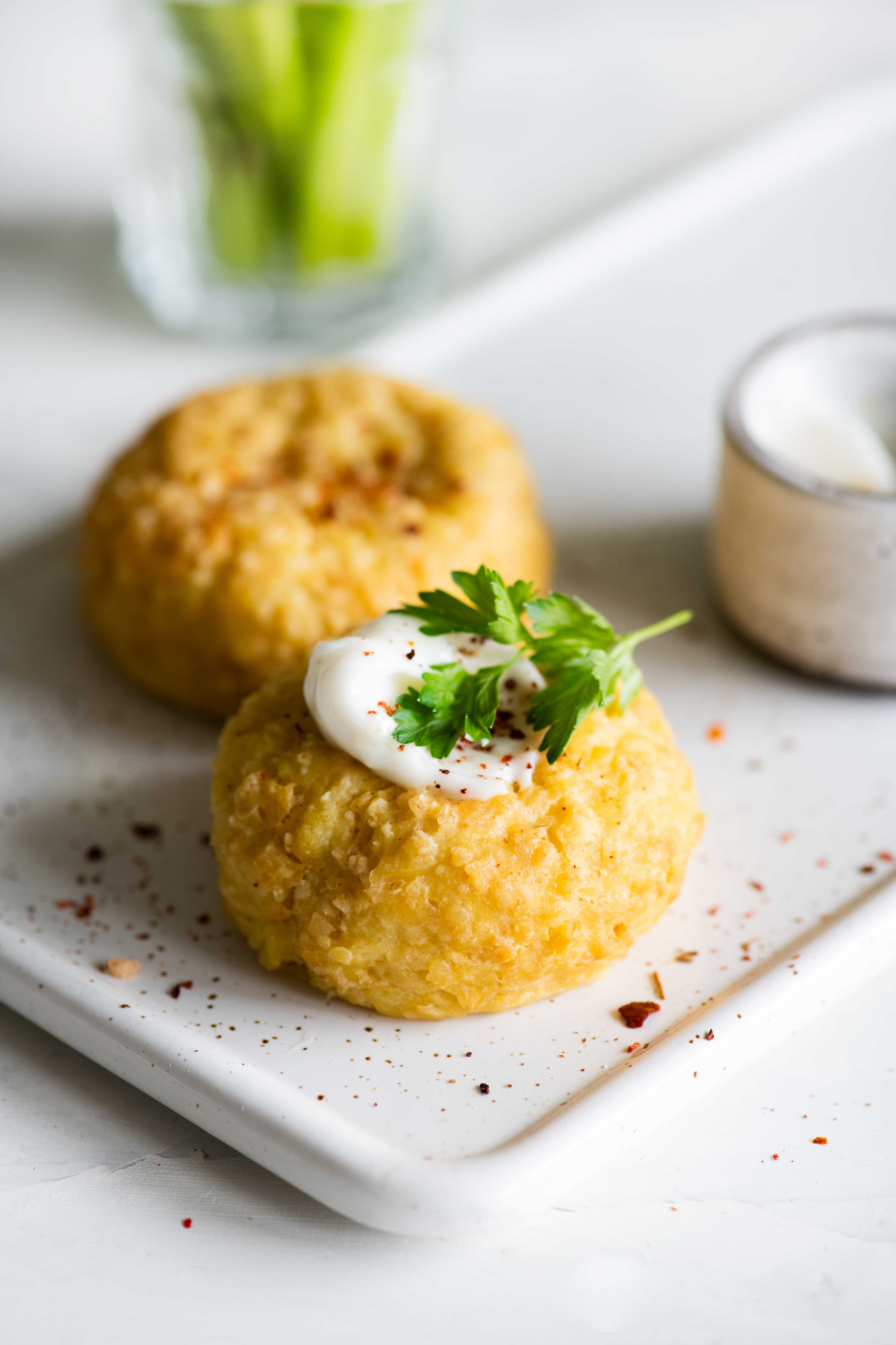 Overhead flat-lay of all ingredients for Sicilian Arancine di Riso with Saffron and Peas laid out on a kitchen surface.