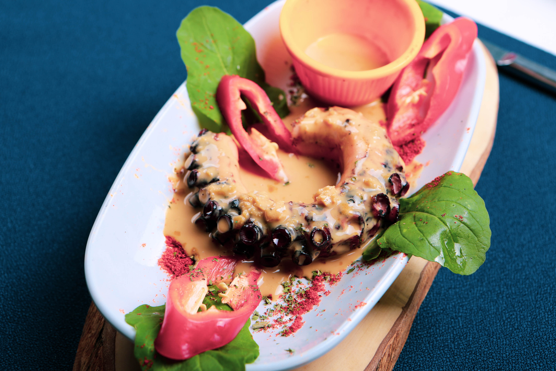 Overhead flat-lay of all ingredients for Sicilian Octopus and Ricotta-Stuffed Pastry with Herb Salsa laid out on a kitchen surface.