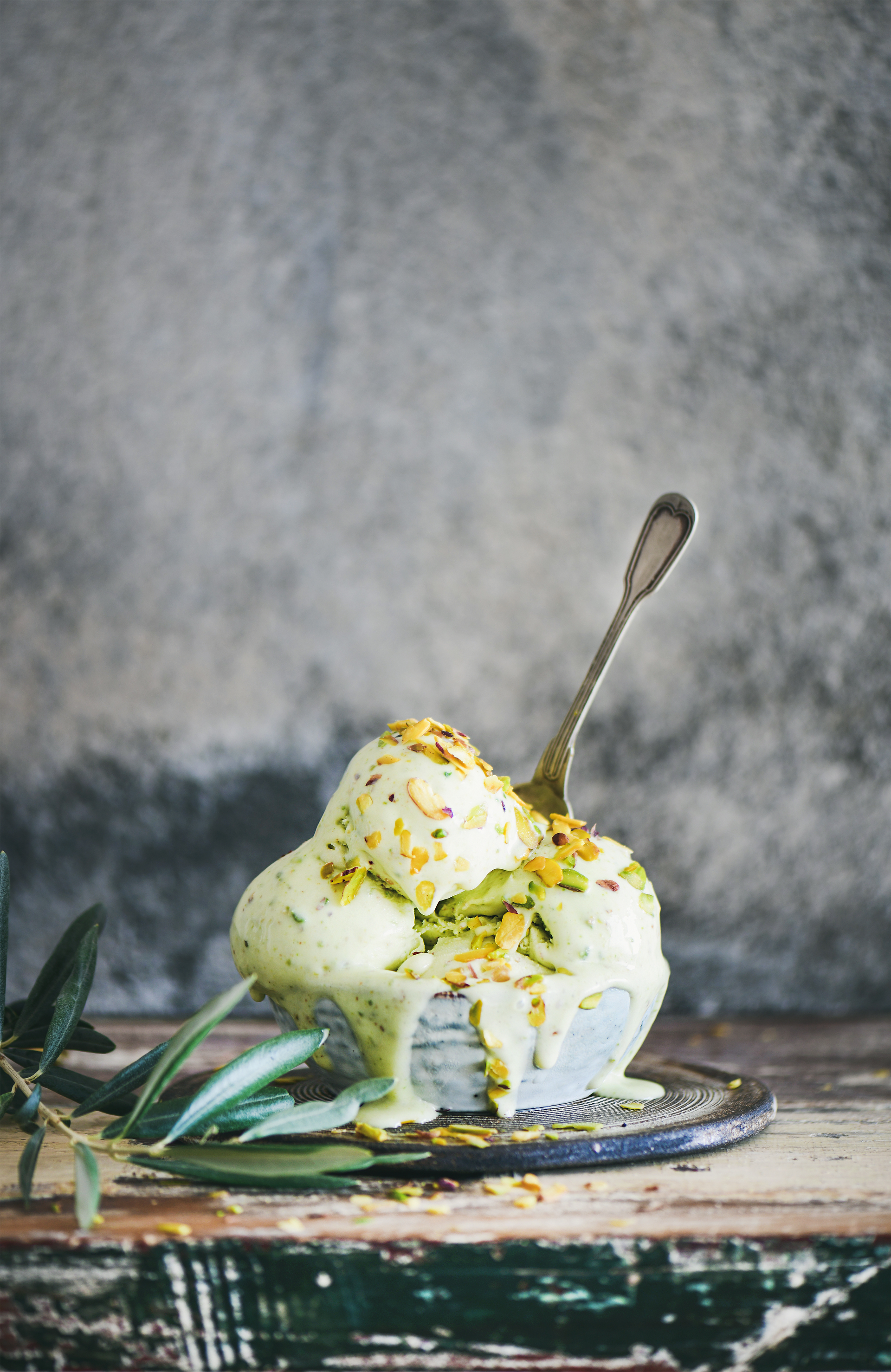 Overhead flat-lay of all ingredients for Sicilian Pistachio Gelato with Lemon Zest laid out on a kitchen surface.
