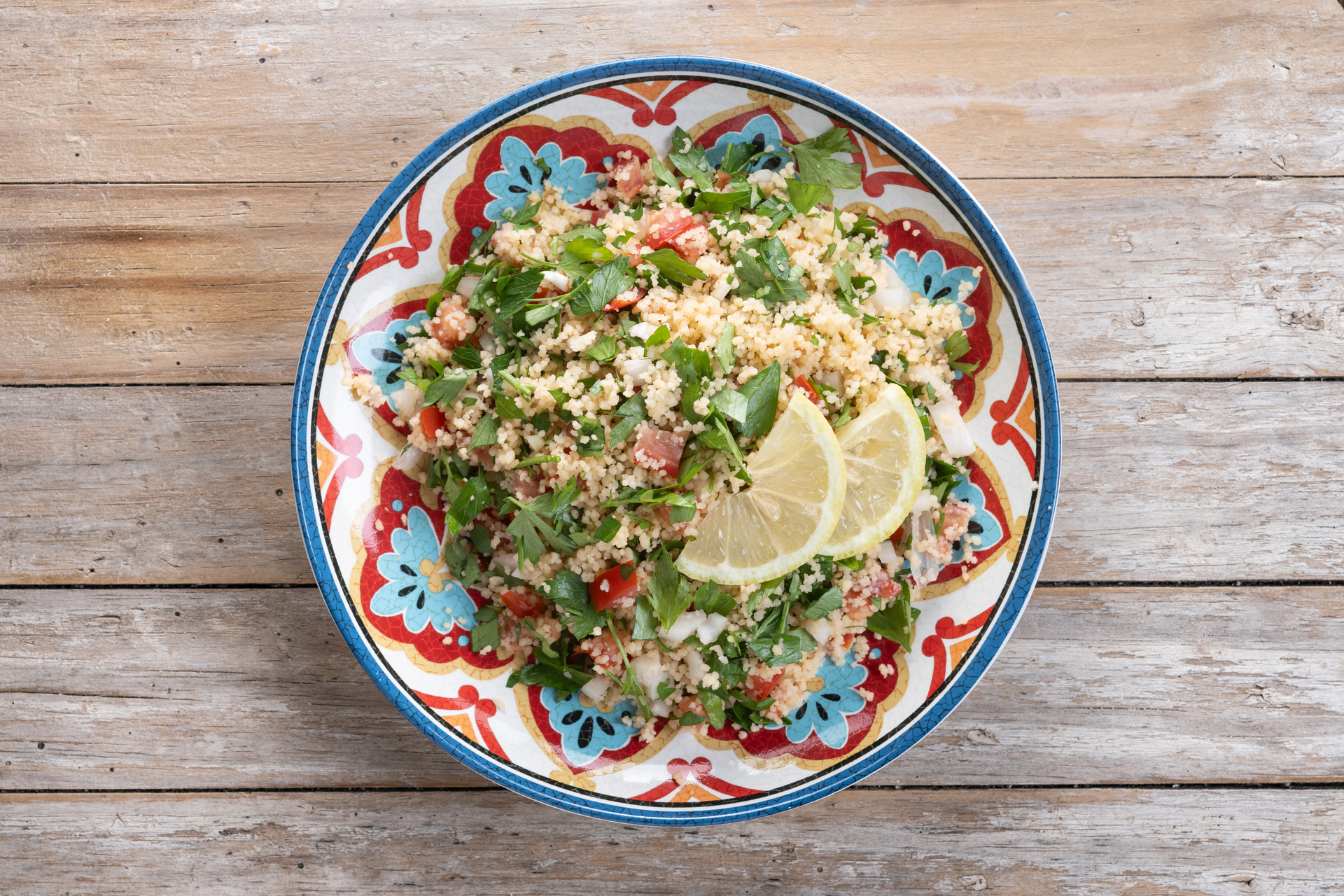 Overhead flat-lay of all ingredients for Silken Lebanese Rice Tabbouleh with Sumac Dressing laid out on a kitchen surface.