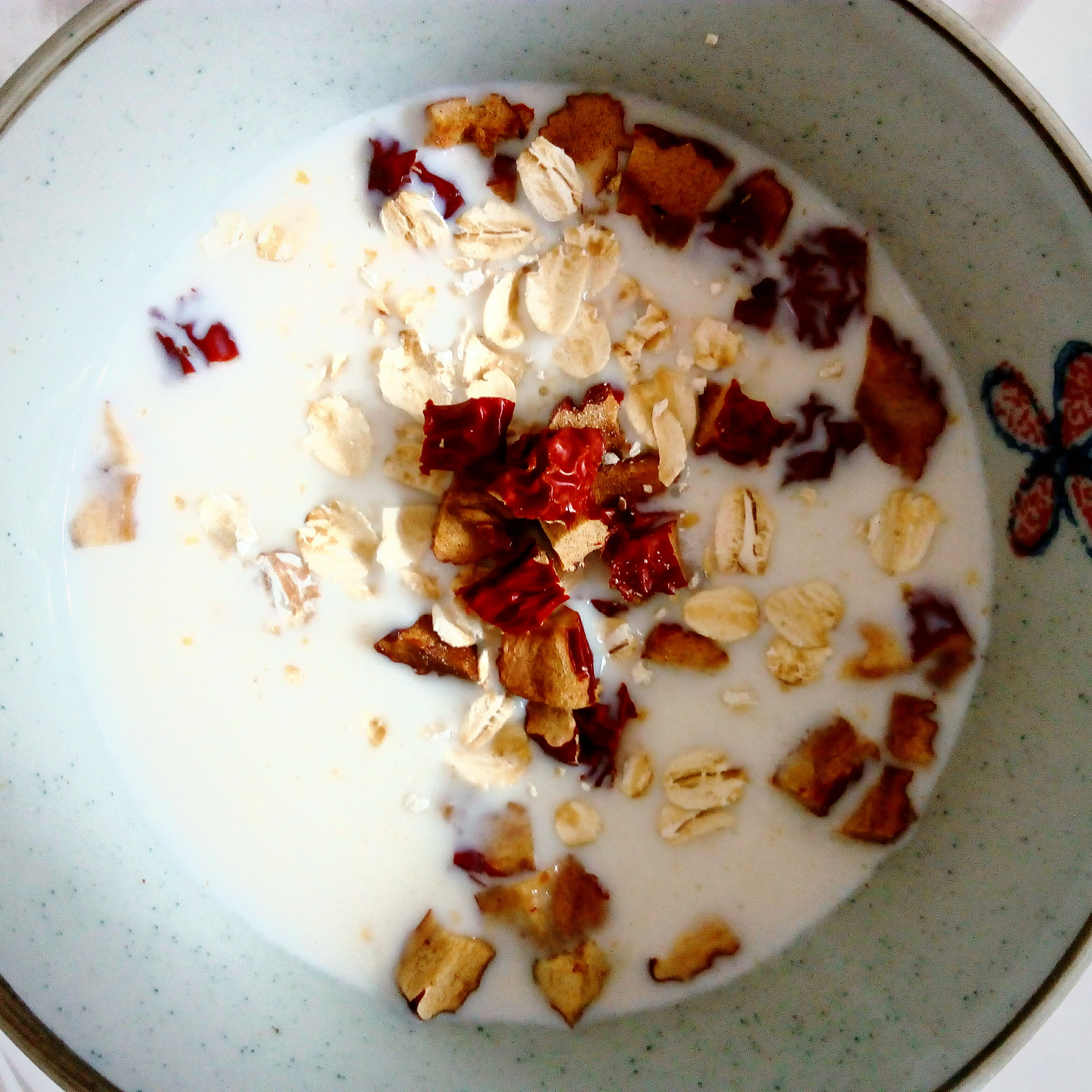 Overhead flat-lay of all ingredients for Silken Moroccan Vanilla Rosewater Pudding with Almond Crunch laid out on a kitchen surface.