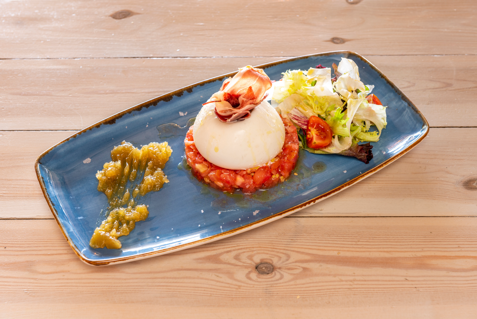 Overhead flat-lay of all ingredients for Silken Spanish Iberian Ham Flan with Manchego Sauce laid out on a kitchen surface.
