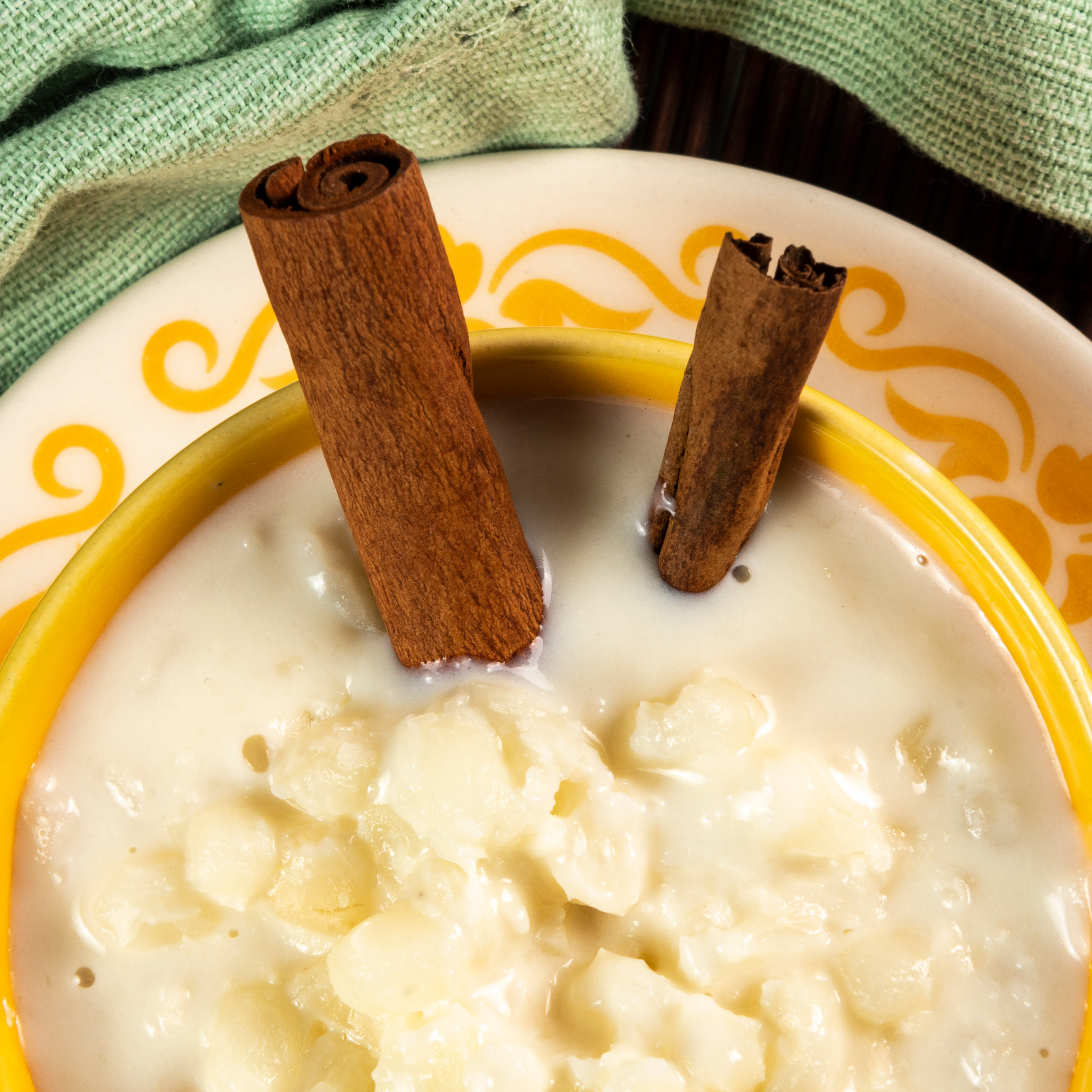 Overhead flat-lay of all ingredients for Silky Brazilian Canjica with Coconut Milk and Condensed Milk laid out on a kitchen surface.