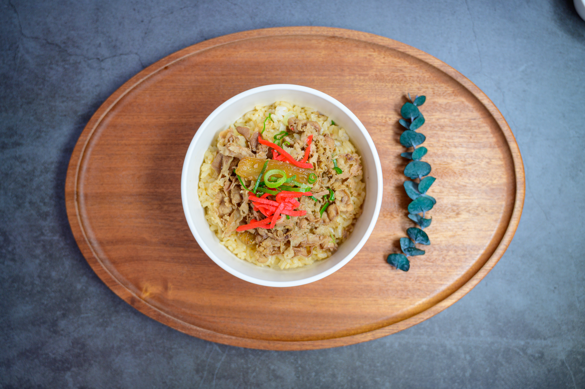 Overhead flat-lay of all ingredients for Silky Indonesian Bubur Manado with Tuna and Basil Leaf laid out on a kitchen surface.
