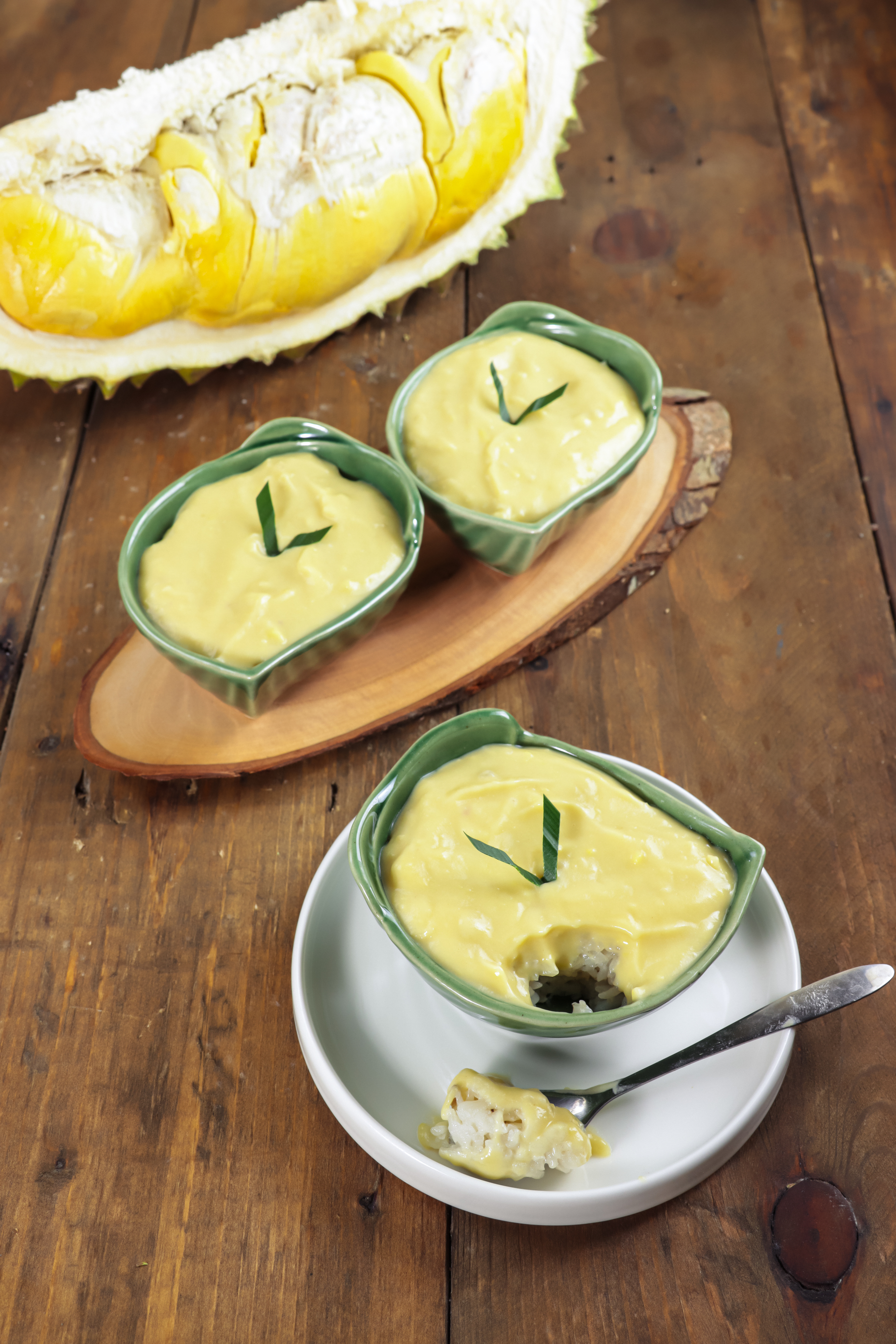 Overhead flat-lay of all ingredients for Silky Vietnamese Durian Custard with Coconut Sauce laid out on a kitchen surface.