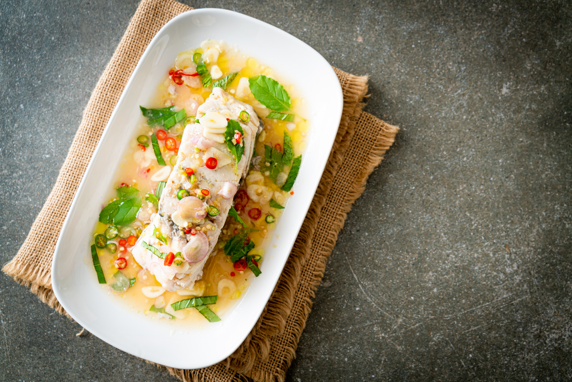 Sinanglay na Tilapia with Coconut Shallot Sauce — Main Course served and photographed from above