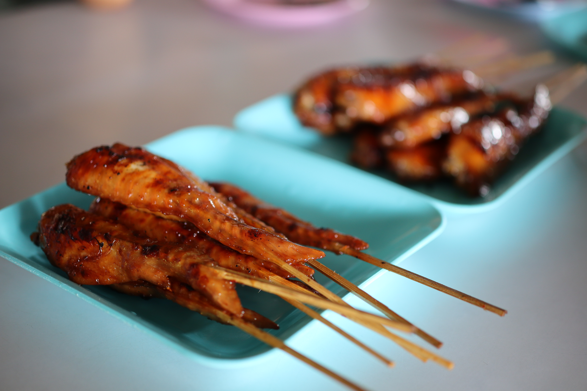 Overhead flat-lay of all ingredients for Smoky Filipino Inasal Chicken Skewers with Calamansi Glaze laid out on a kitchen surface.