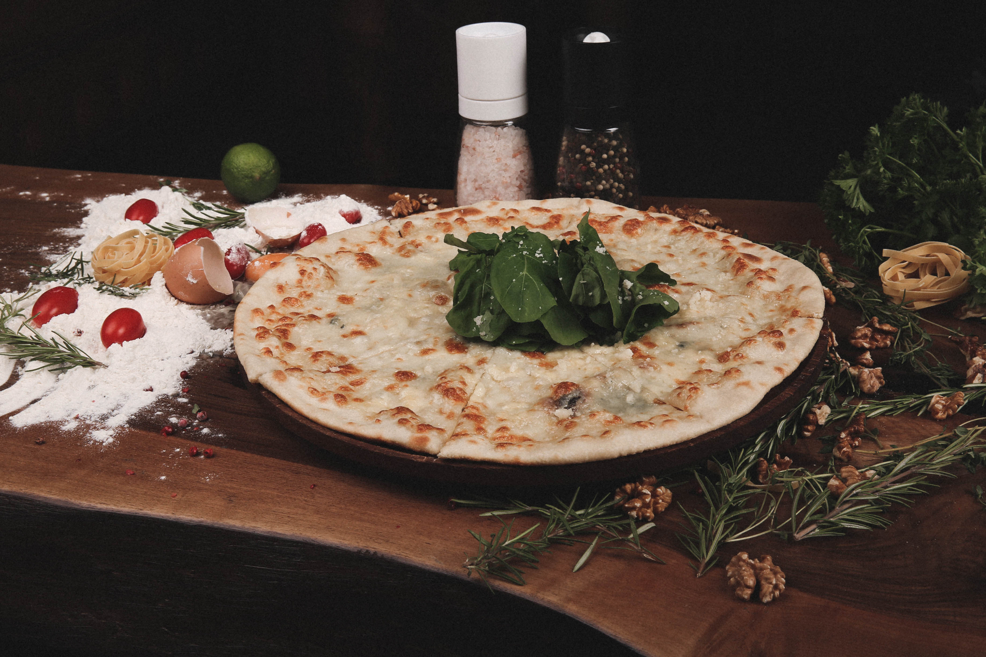Overhead flat-lay of all ingredients for Smoky Lebanese Manakish with Thyme and Sumac laid out on a kitchen surface.