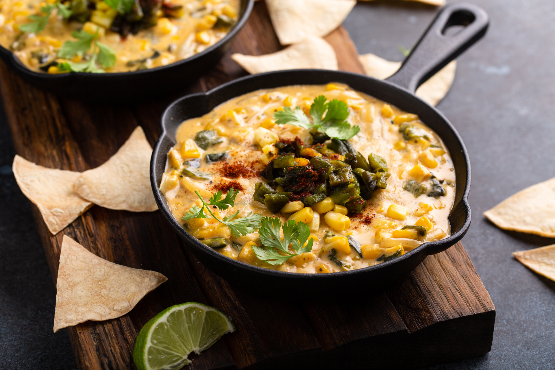 Overhead flat-lay of all ingredients for Smoky Mexican Chipotle Corn Soup with Lime laid out on a kitchen surface.