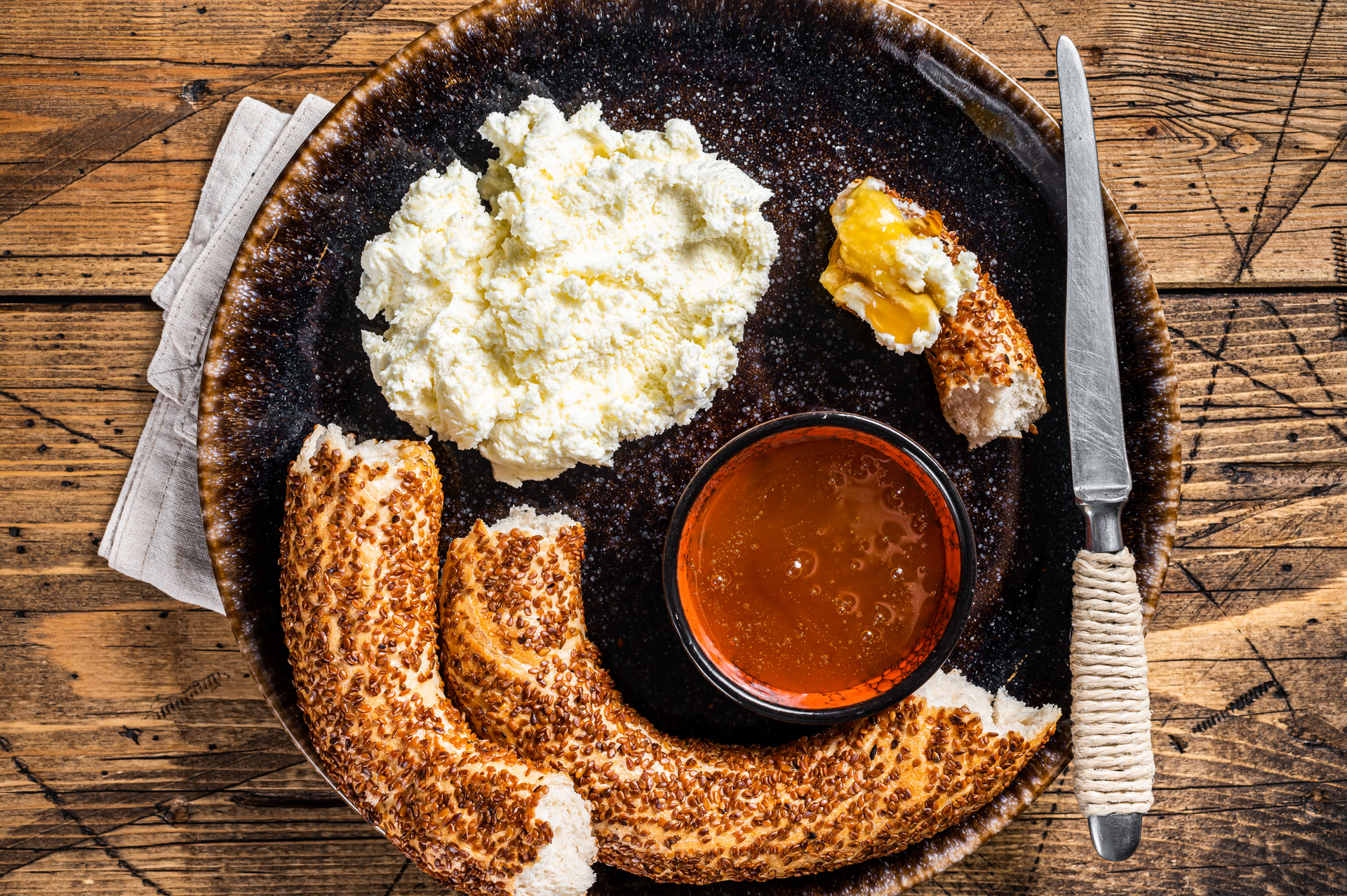 Overhead flat-lay of all ingredients for Smoky Serbian Pljeskavica with Ajvar and Kajmak laid out on a kitchen surface.