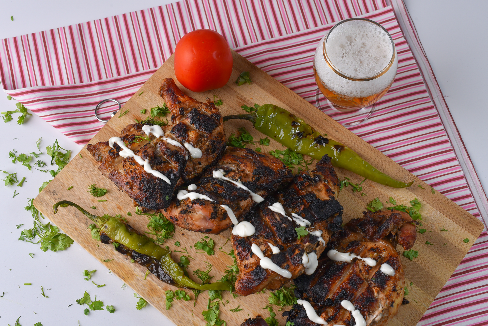 Overhead flat-lay of all ingredients for Smoky Syrian Grilled Lamb Kebab with Sumac and Yogurt Sauce laid out on a kitchen surface.