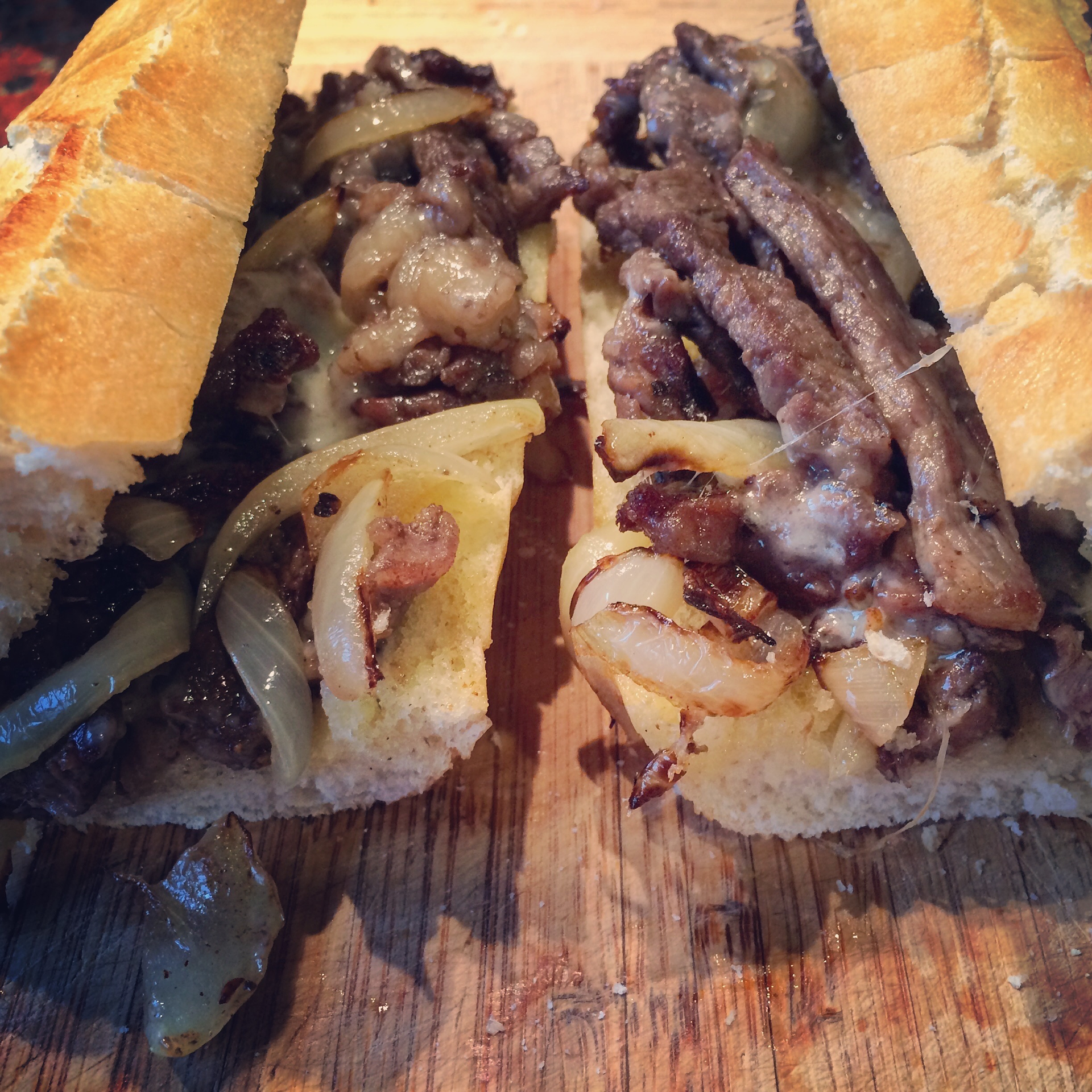 Overhead flat-lay of all ingredients for Smoky Uruguayan Chivito Sandwich laid out on a kitchen surface.