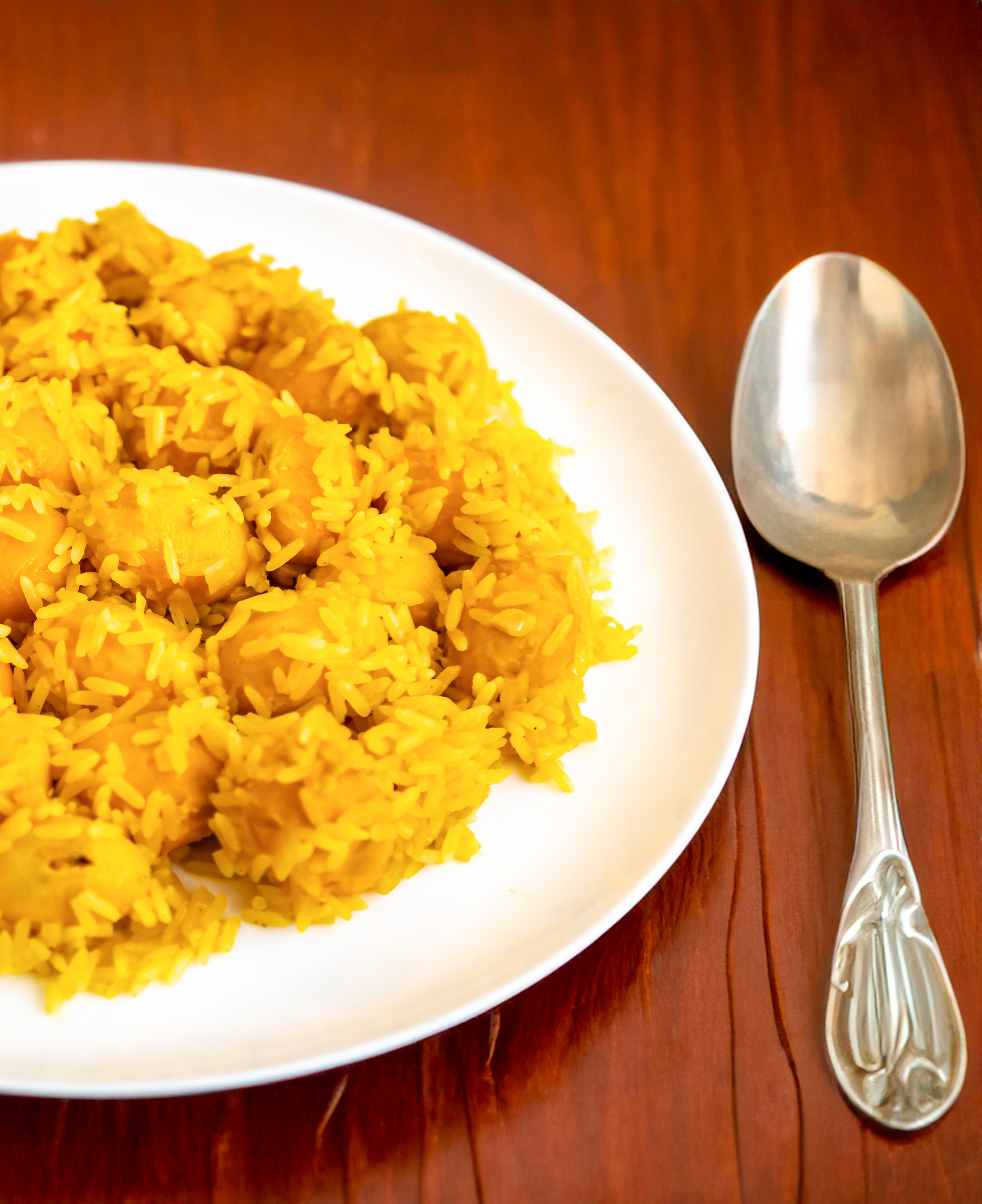 Overhead flat-lay of all ingredients for South African Bobotie with Yellow Rice and Chutney laid out on a kitchen surface.