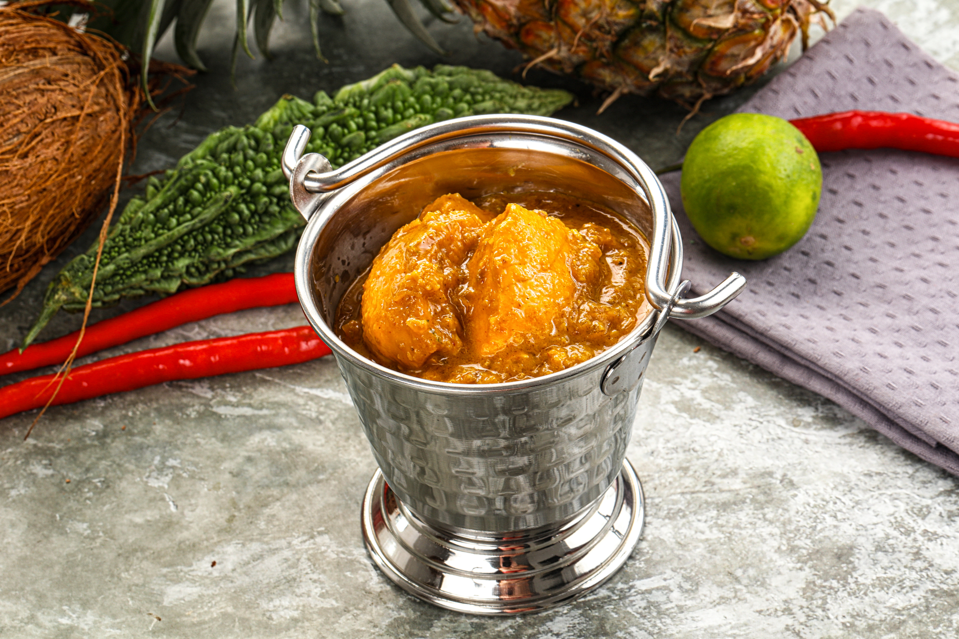 Overhead flat-lay of all ingredients for South Indian Drumstick Sambar with Spiced Tamarind Broth laid out on a kitchen surface.