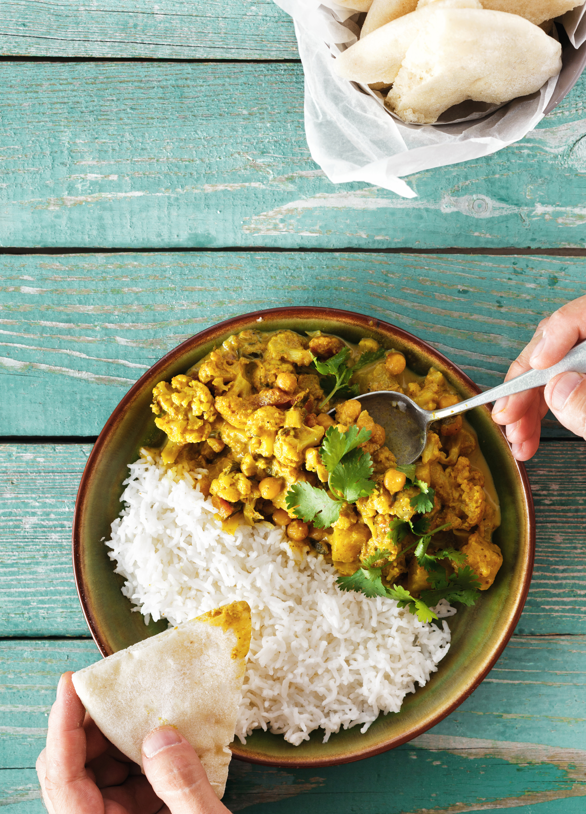 Overhead flat-lay of all ingredients for South Indian Lemon Rice with Chana Dal and Curry Leaves laid out on a kitchen surface.