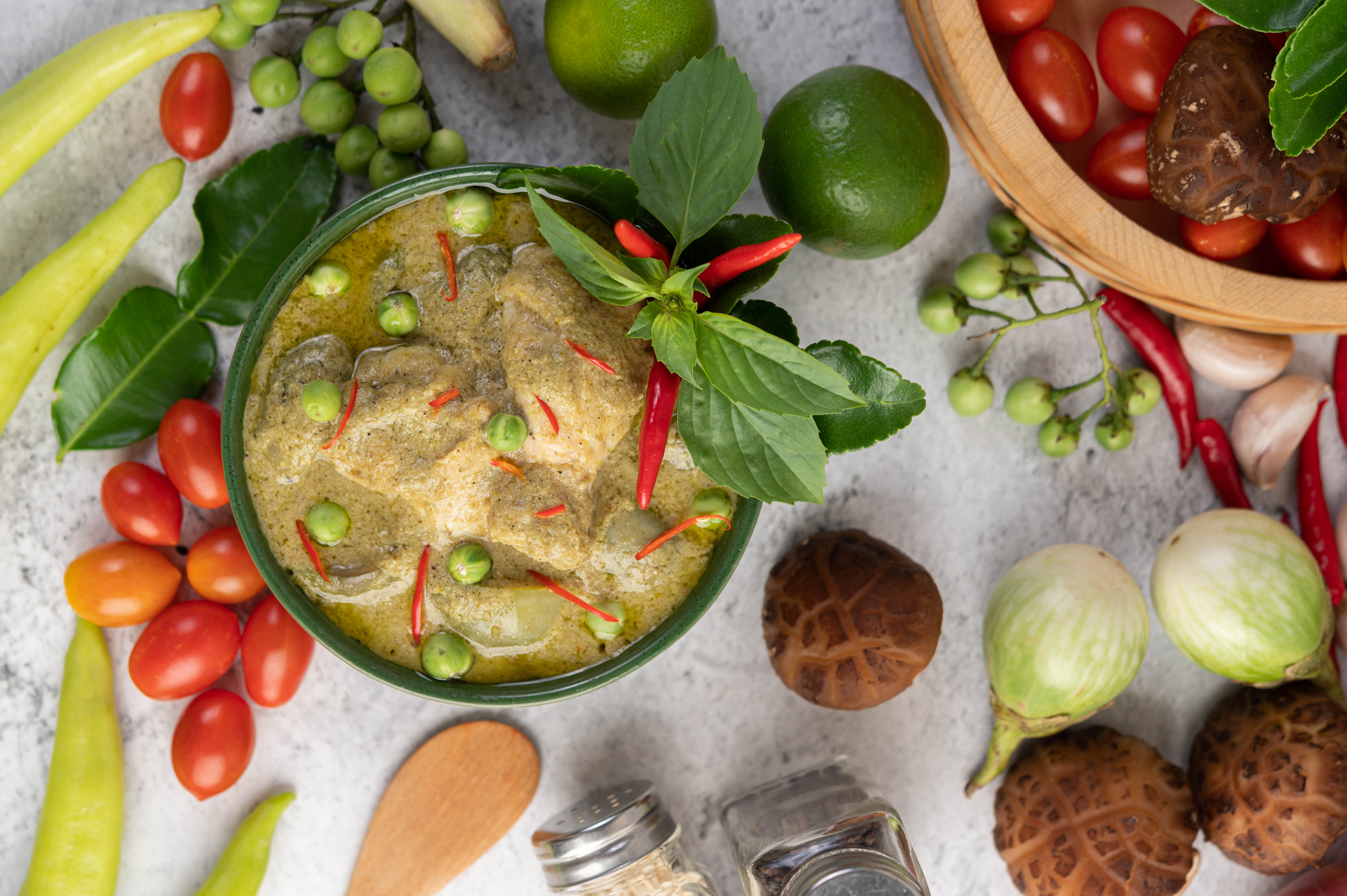 Southeast Asian Tamarind Chicken in Banana Leaf with Mint Chutney — Main Course served and photographed from above