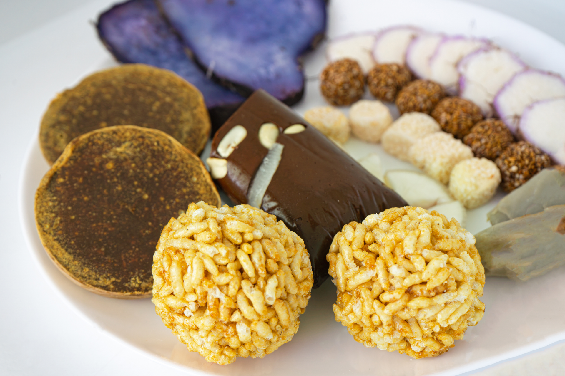 Overhead flat-lay of all ingredients for Southern Indian Tamarind Rice Balls with Spiced Peanuts laid out on a kitchen surface.