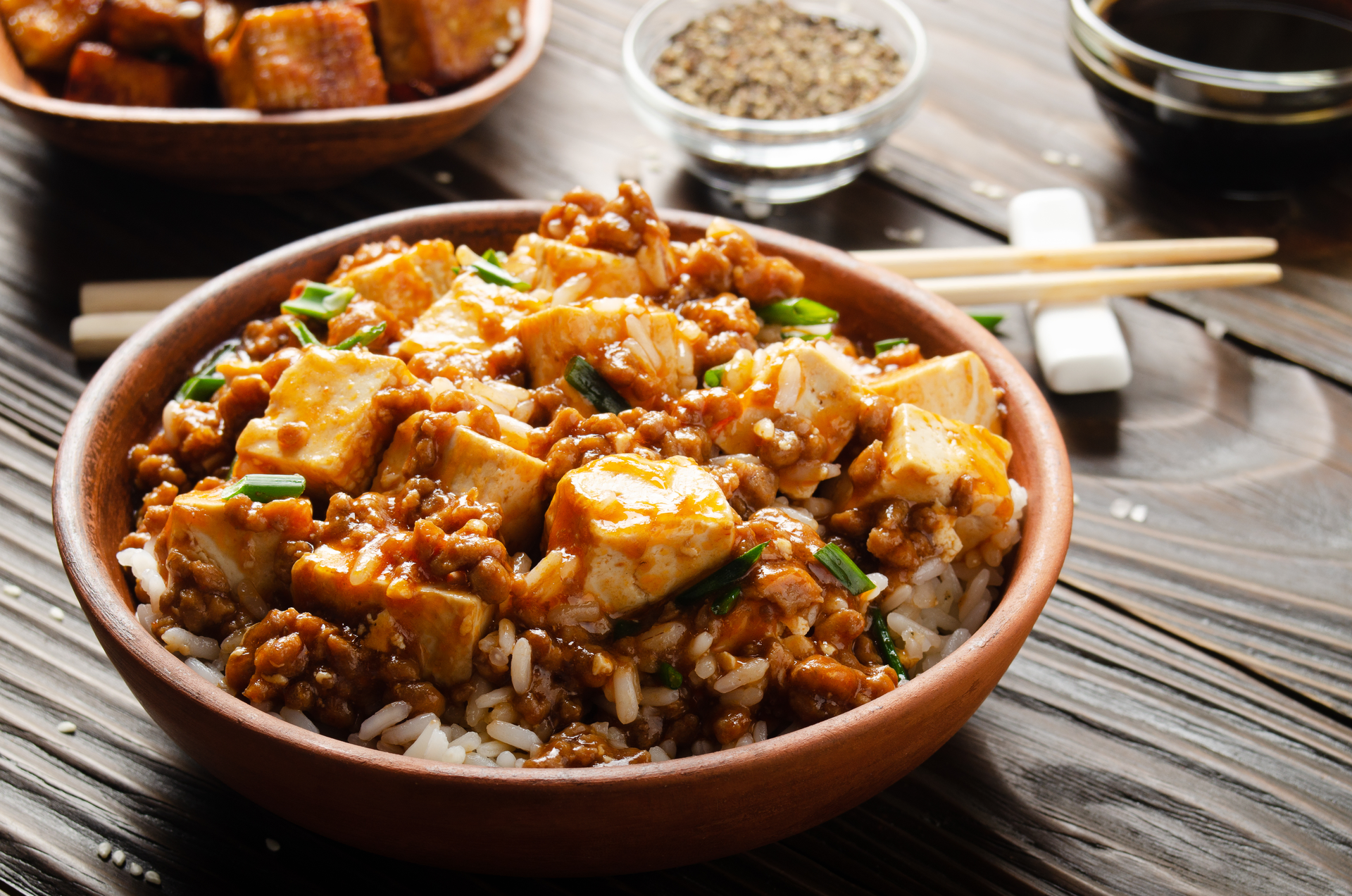 Overhead flat-lay of all ingredients for Soy-Glazed Indonesian Tofu Scramble with Turmeric Rice laid out on a kitchen surface.
