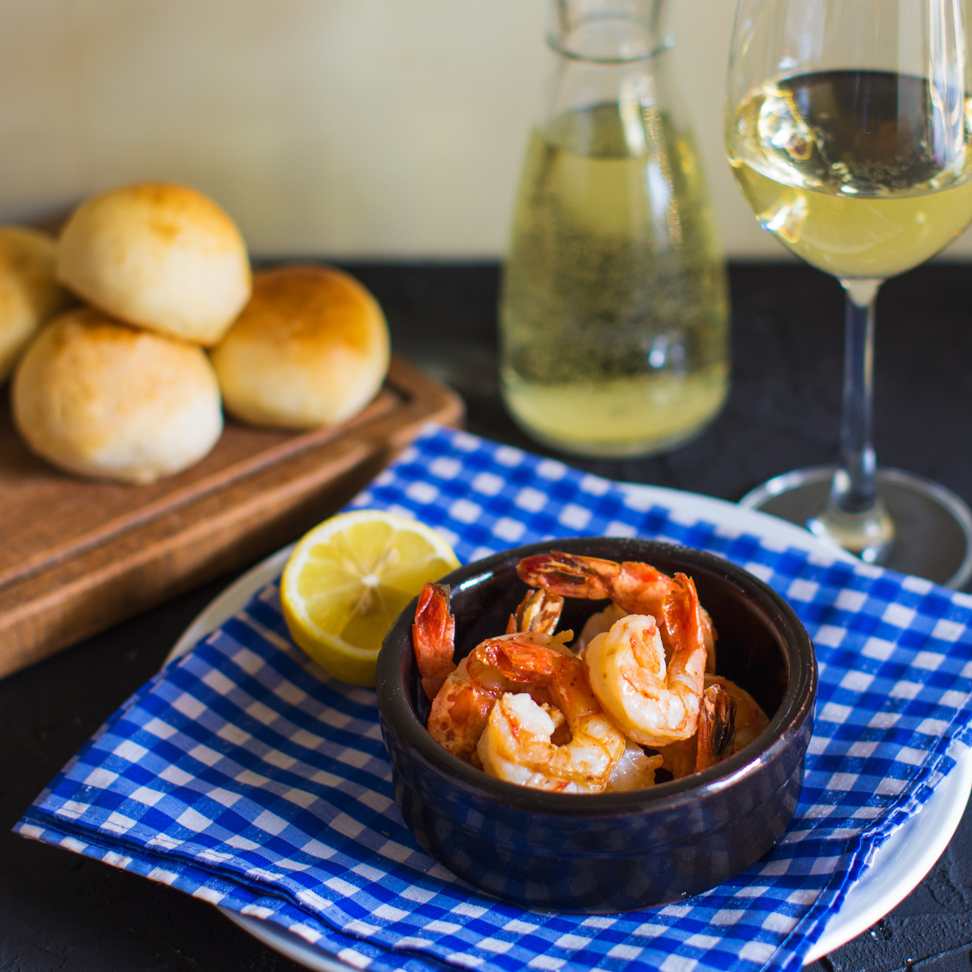 Overhead flat-lay of all ingredients for Spanish Gambas al Ajillo with Garlic and Parsley laid out on a kitchen surface.