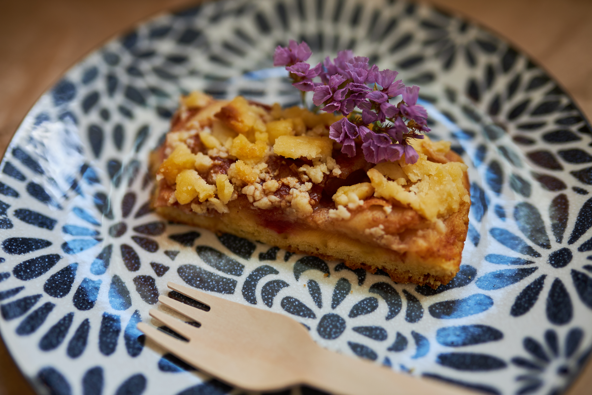 Overhead flat-lay of all ingredients for Spanish Manchego Tart with Crushed Almond and Honey Drizzle laid out on a kitchen surface.