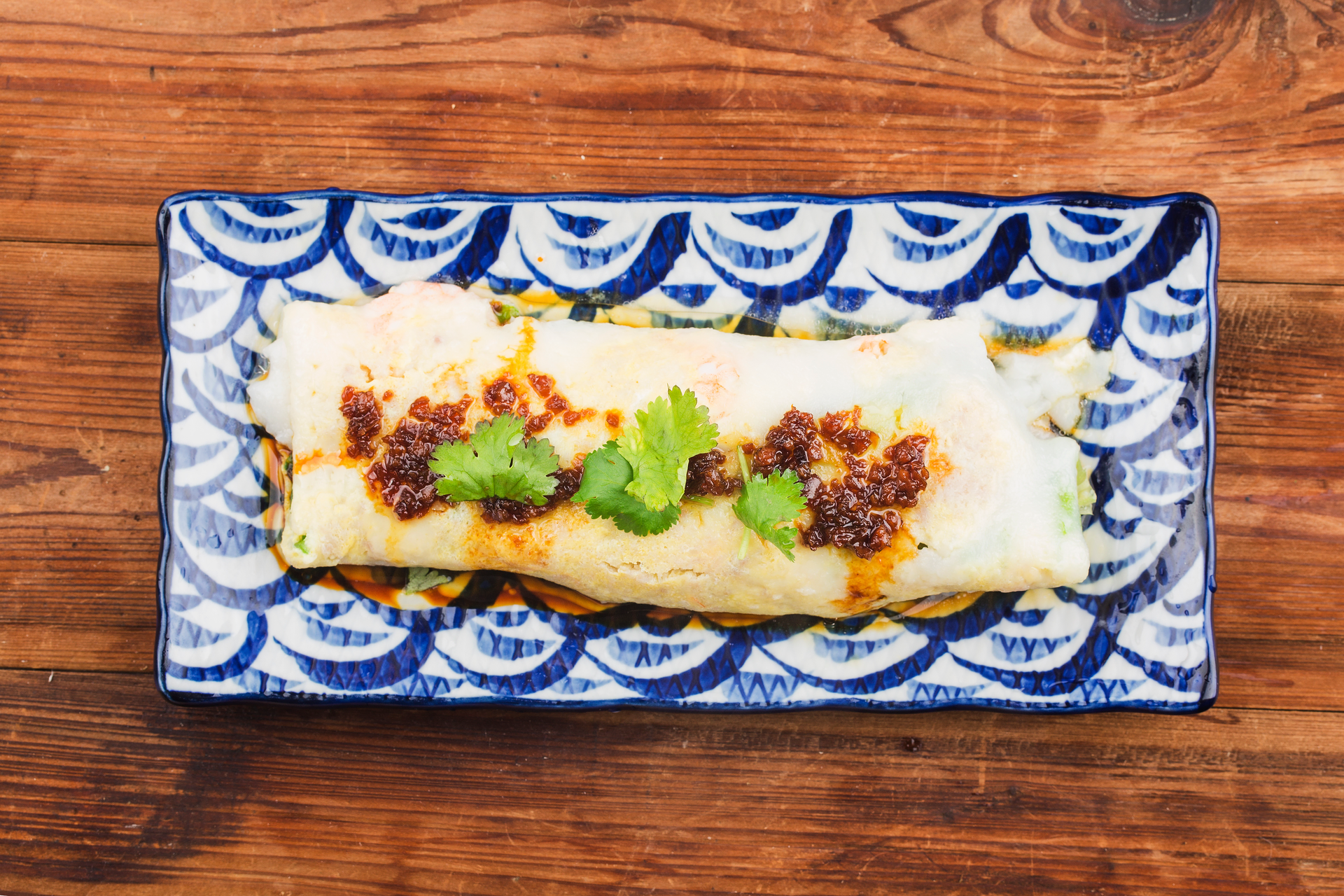 Overhead flat-lay of all ingredients for Spanish Romesco Enchiladas with Manchego Cheese laid out on a kitchen surface.