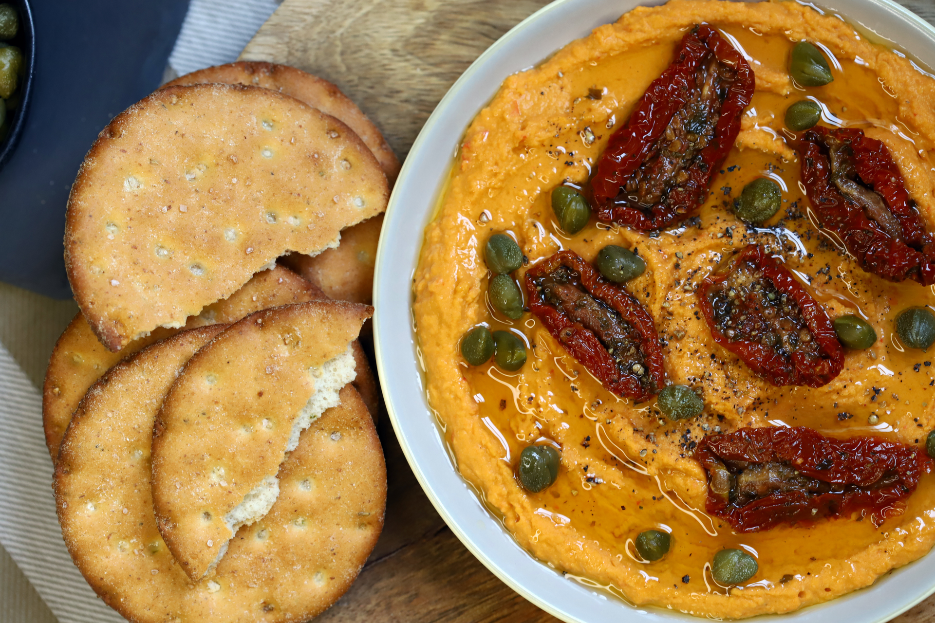 Overhead flat-lay of all ingredients for Spanish Romesco Sauce with Grilled Calçots laid out on a kitchen surface.