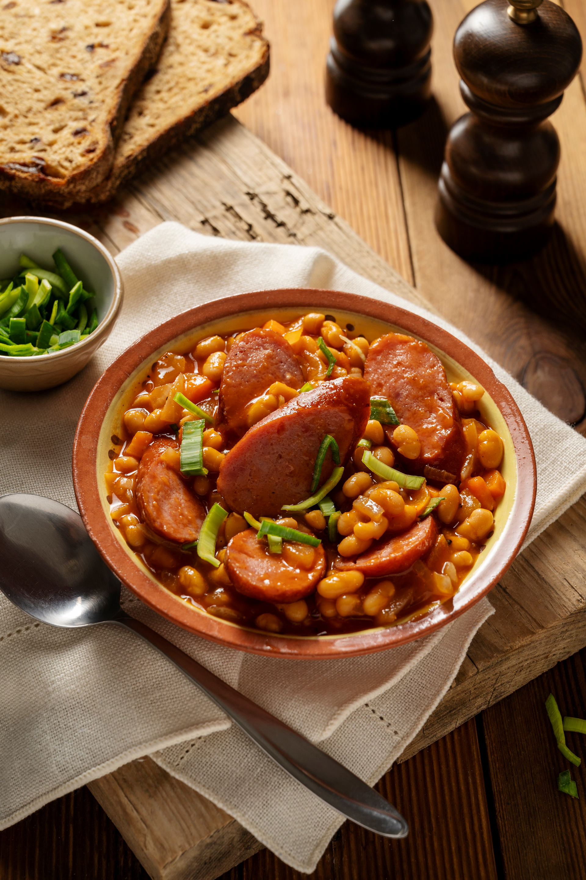 Overhead flat-lay of all ingredients for Spanish Saffron and Chorizo Stew with White Beans laid out on a kitchen surface.