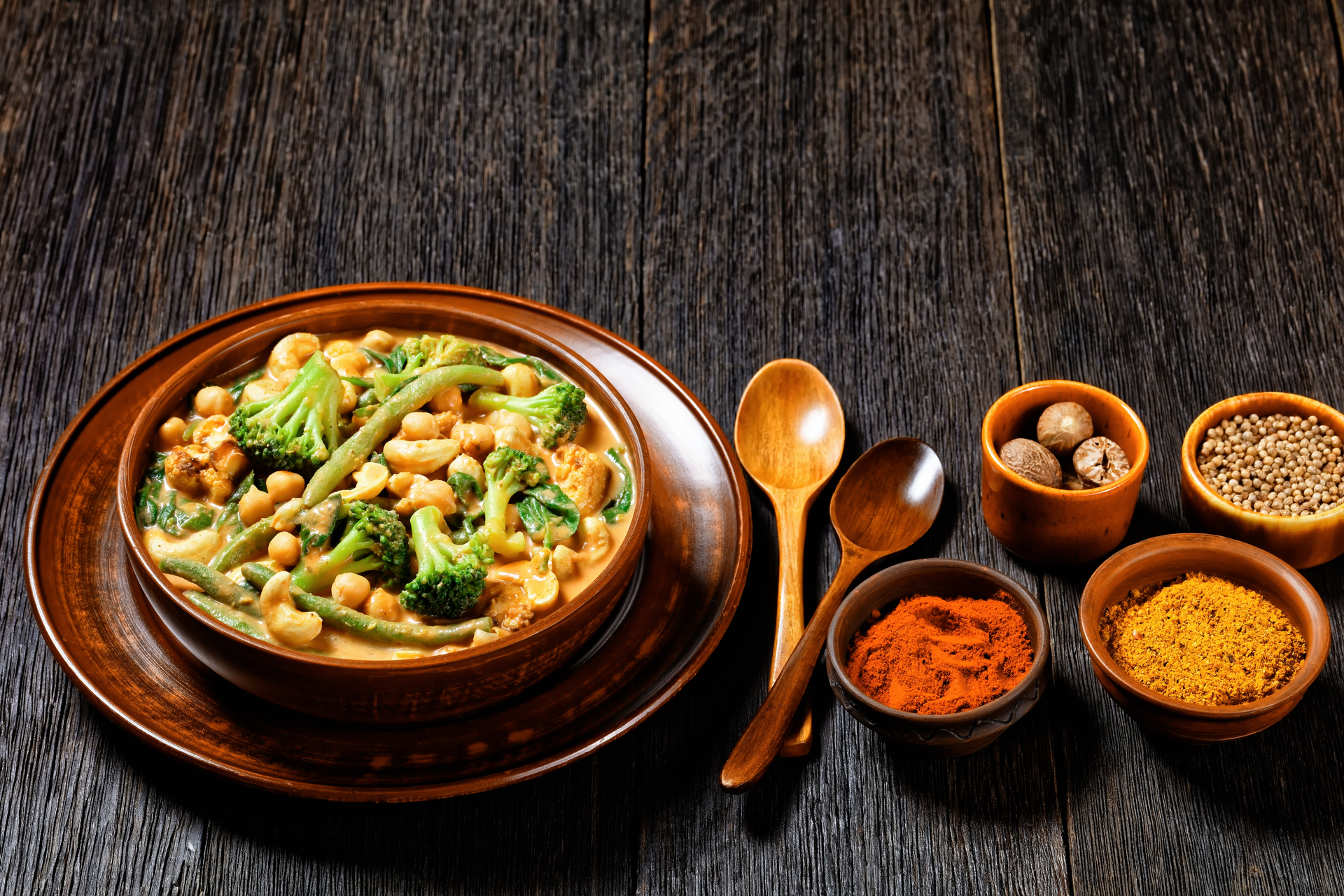 Overhead flat-lay of all ingredients for Spiced Indian Chana Masala with Cumin and Coriander laid out on a kitchen surface.
