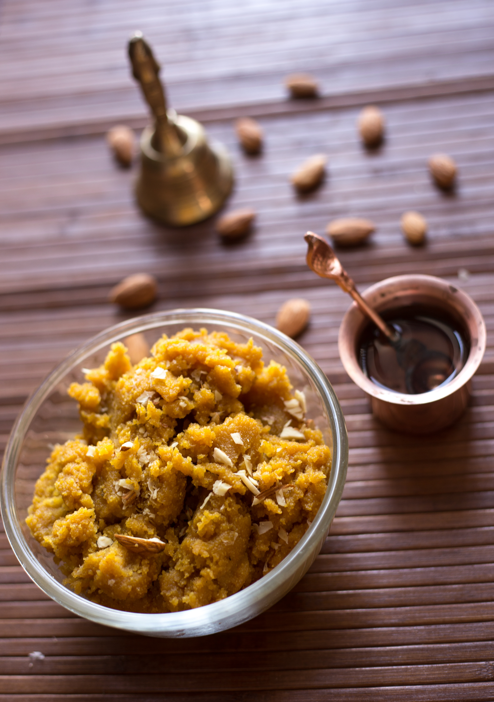 Overhead flat-lay of all ingredients for Spiced Indian Gajar Halwa with Cardamom and Cashew Nut laid out on a kitchen surface.