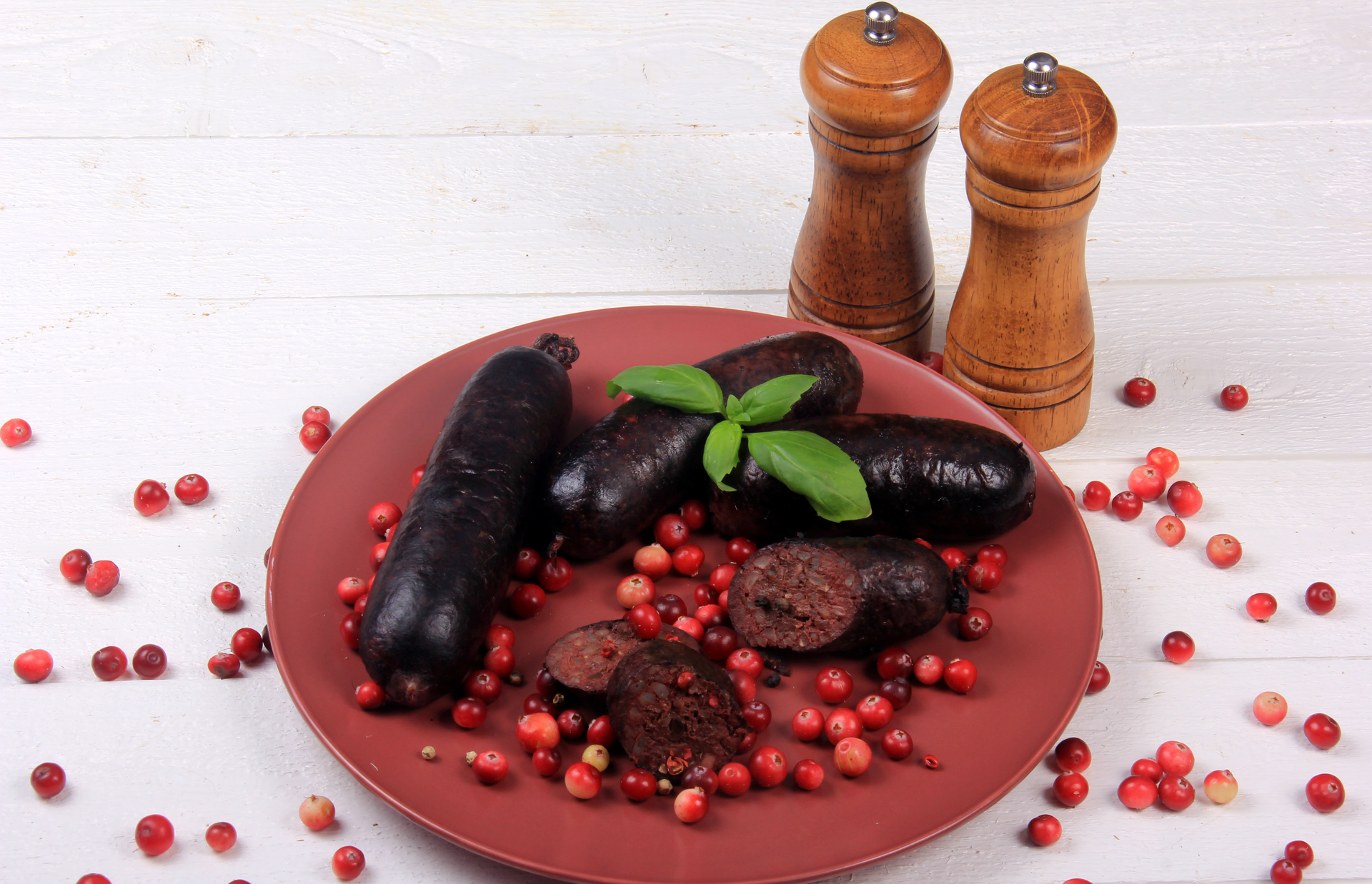 Overhead flat-lay of all ingredients for Spiced Lebanese Makanek Sausages with Pomegranate Molasses laid out on a kitchen surface.