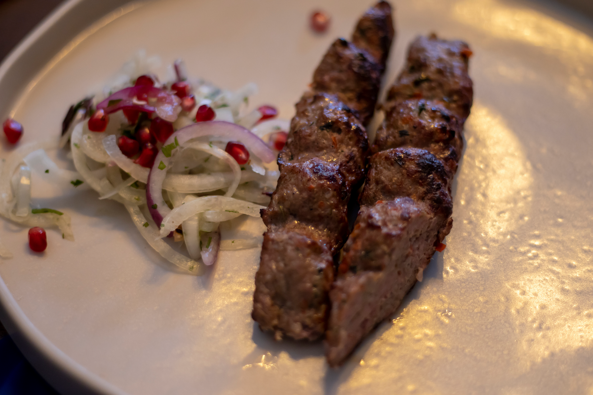 Overhead flat-lay of all ingredients for Spiced Middle Eastern Kafta with Garlic Sauce laid out on a kitchen surface.