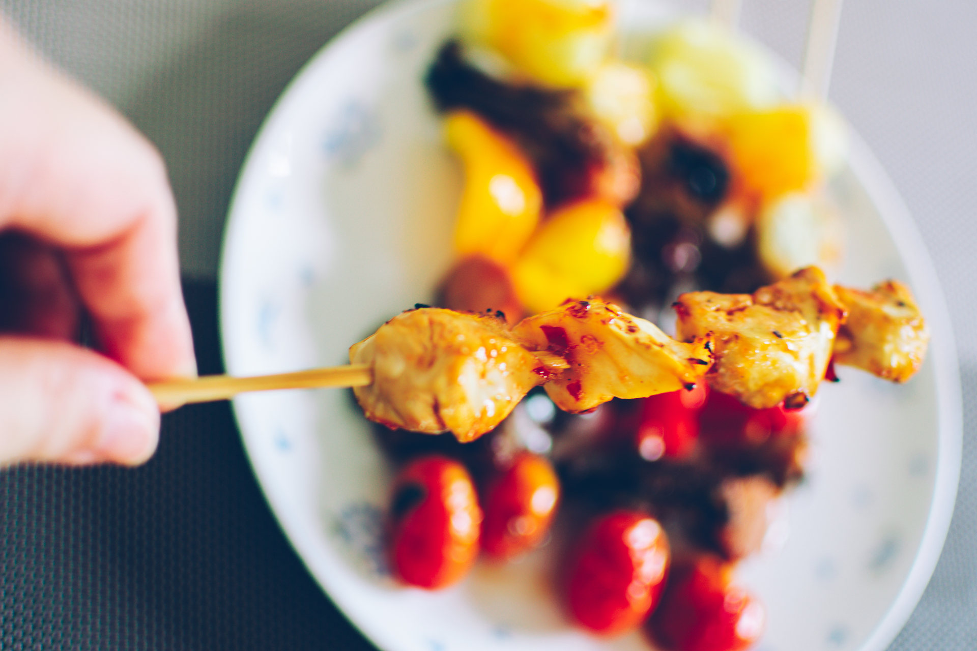 Overhead flat-lay of all ingredients for Spiced Rwandan Brochettes with Pili Pili Sauce laid out on a kitchen surface.