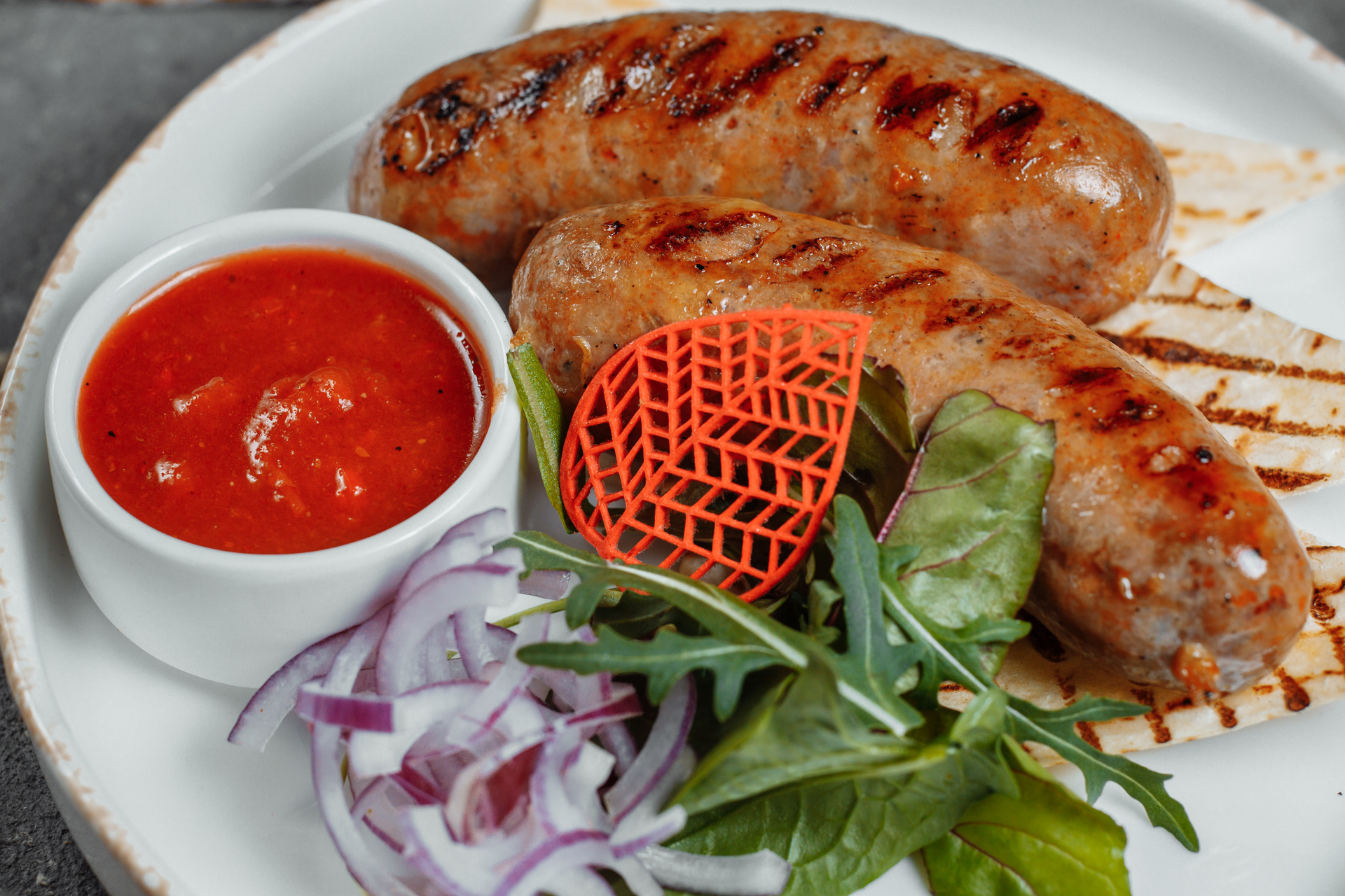 Spicy Algerian Merguez Sausage with Harissa Yogurt — Appetizer served and photographed from above