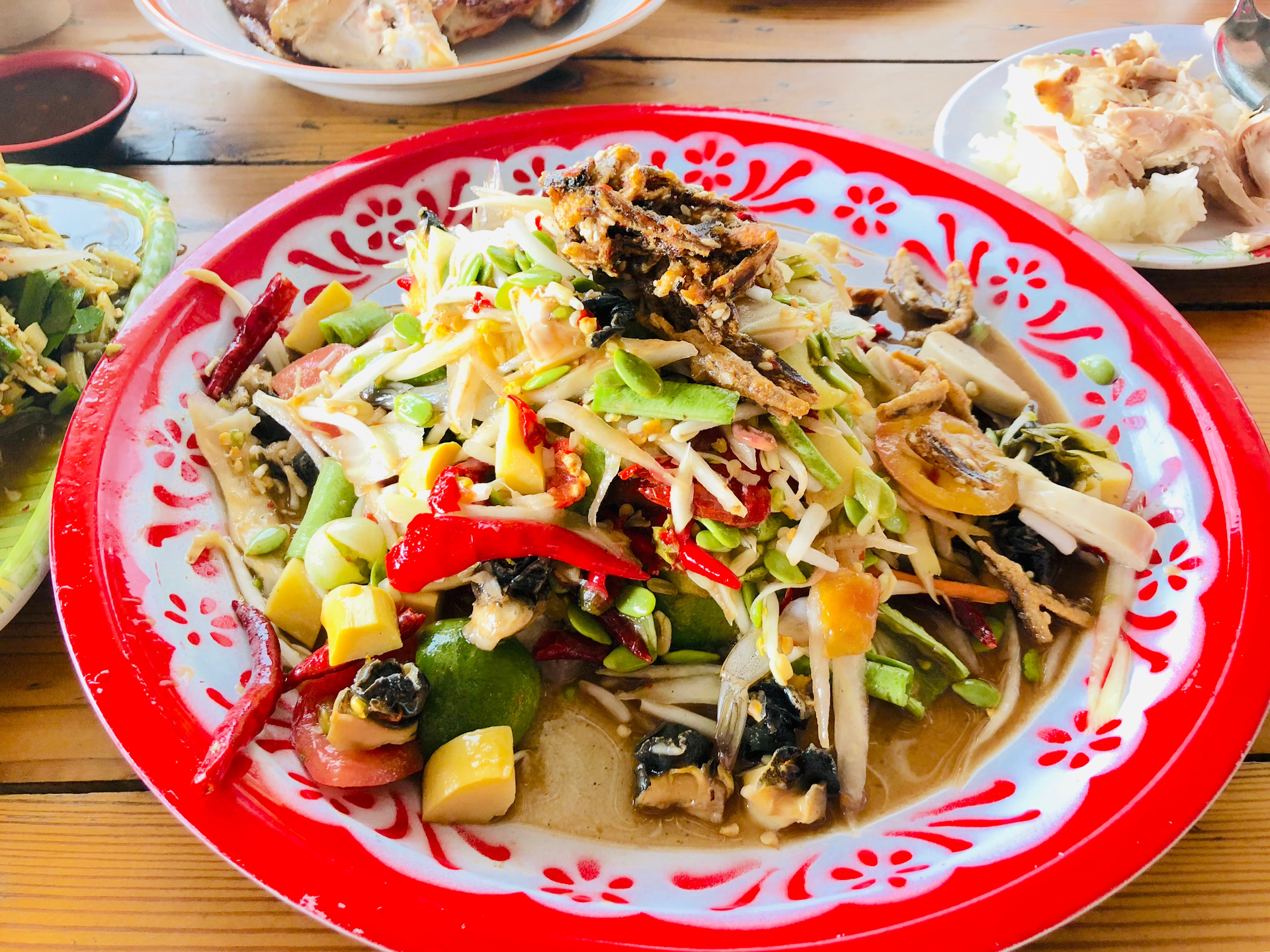 Overhead flat-lay of all ingredients for Spicy Bhutanese Ema Datshi with Fresh Chilies and Cheese laid out on a kitchen surface.