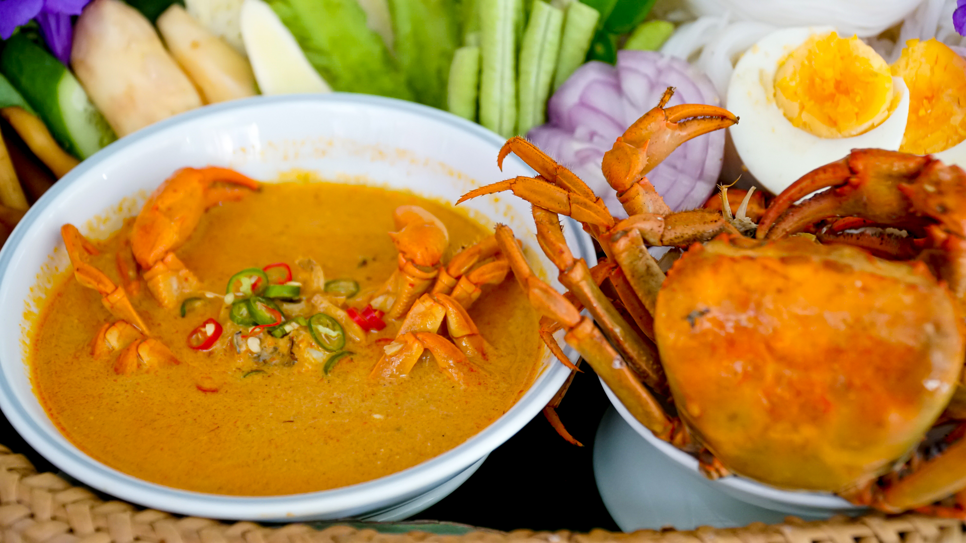 Overhead flat-lay of all ingredients for Spicy Caribbean Coconut Curry Crab with Lime Zest laid out on a kitchen surface.
