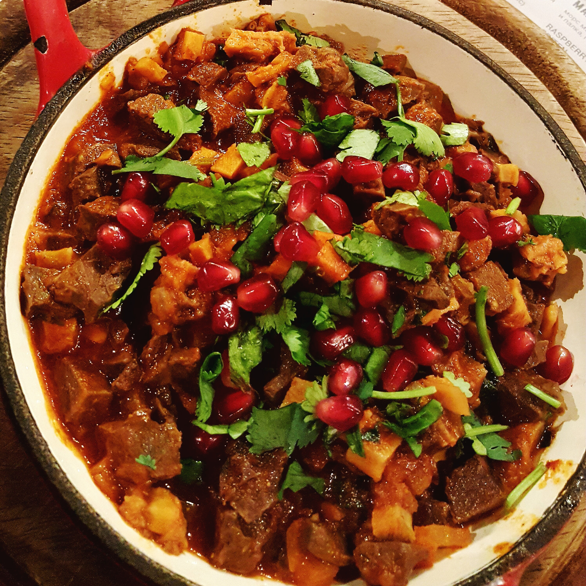 Spicy Caribbean Goat Pepperpot with Cassareep and Sorrel — Main Course served and photographed from above