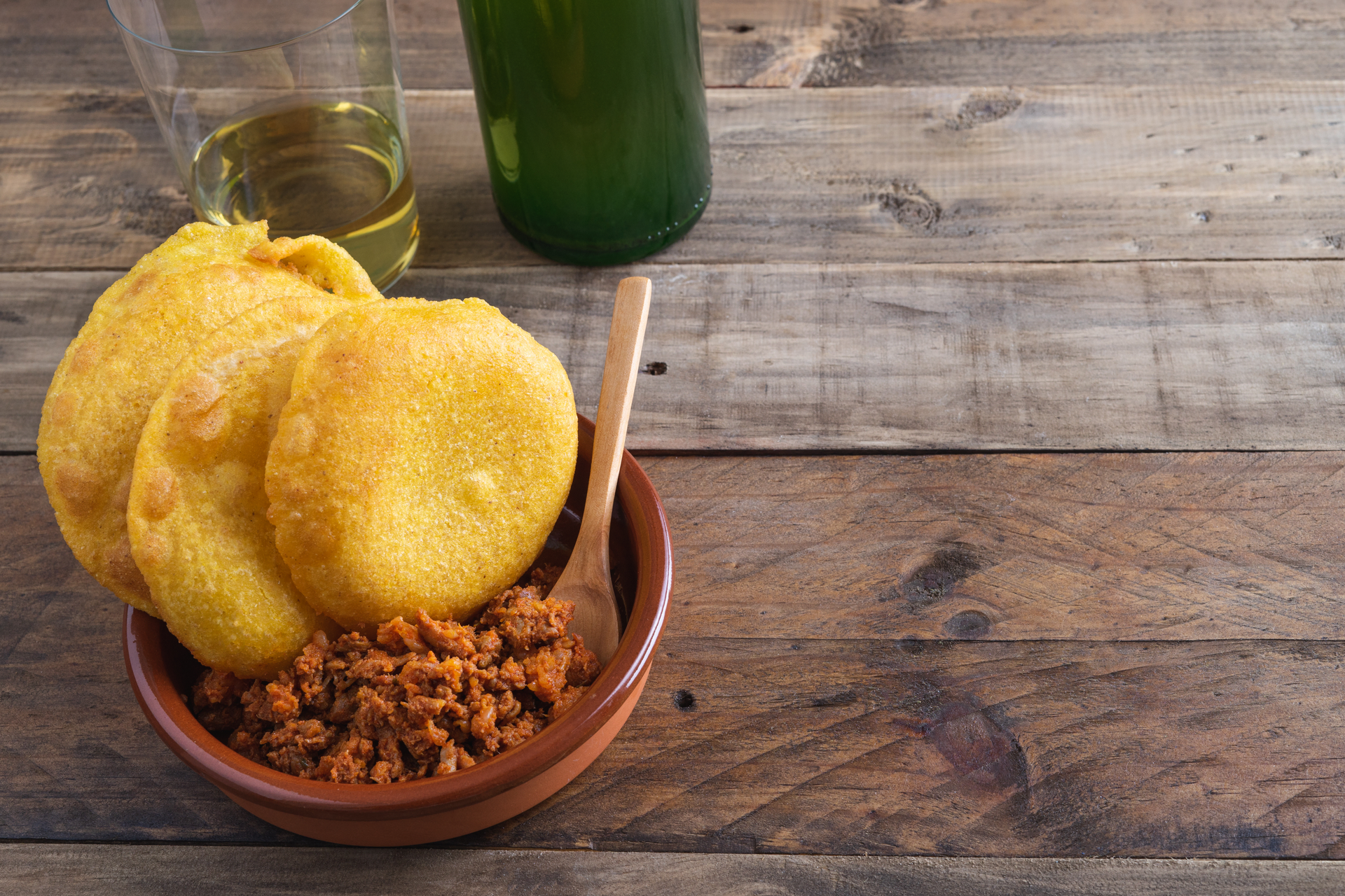 Spicy Colombian Chunchullo with Arepas — Appetizer served and photographed from above