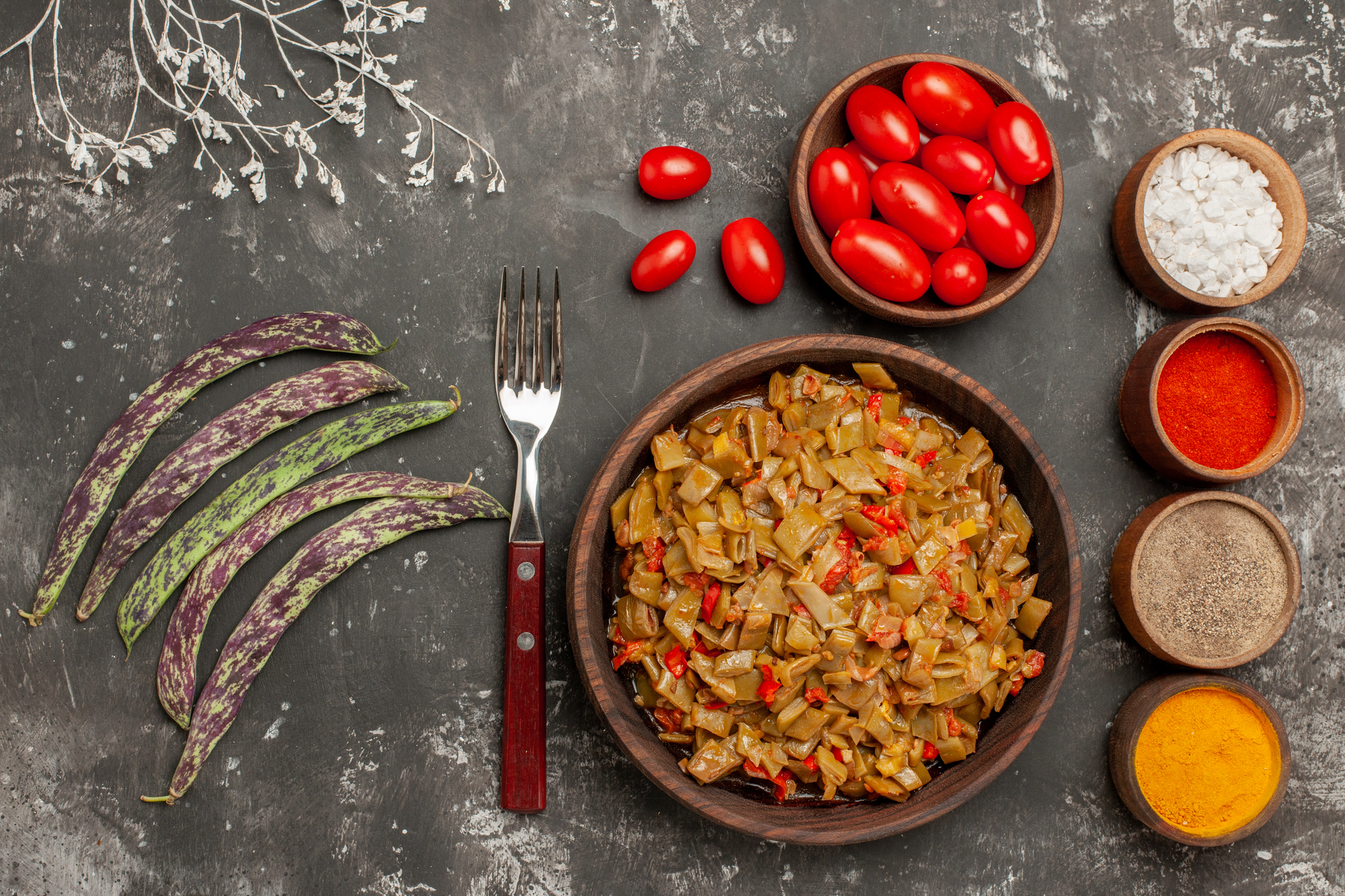 Overhead flat-lay of all ingredients for Spicy Egyptian Koshari with Zesty Hot Sauce laid out on a kitchen surface.