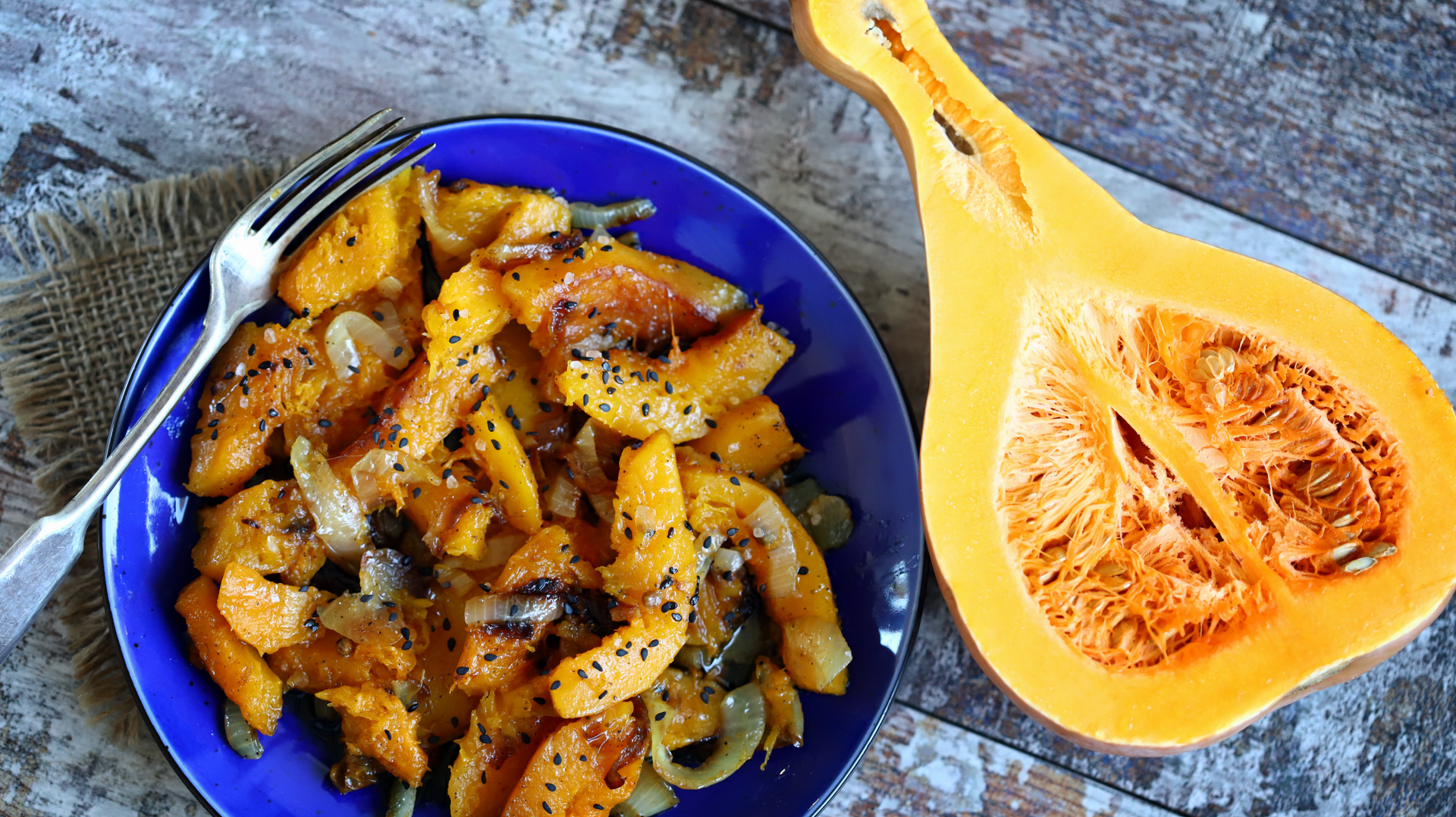 Overhead flat-lay of all ingredients for Spicy Guatemalan Pepián de Pollo with Toasted Pumpkin Seeds laid out on a kitchen surface.