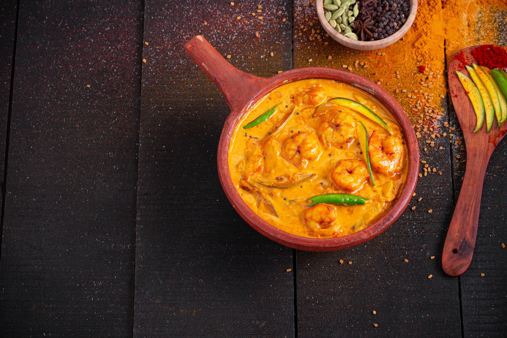 Overhead flat-lay of all ingredients for Spicy Indian Goan Prawn Curry with Kokum laid out on a kitchen surface.