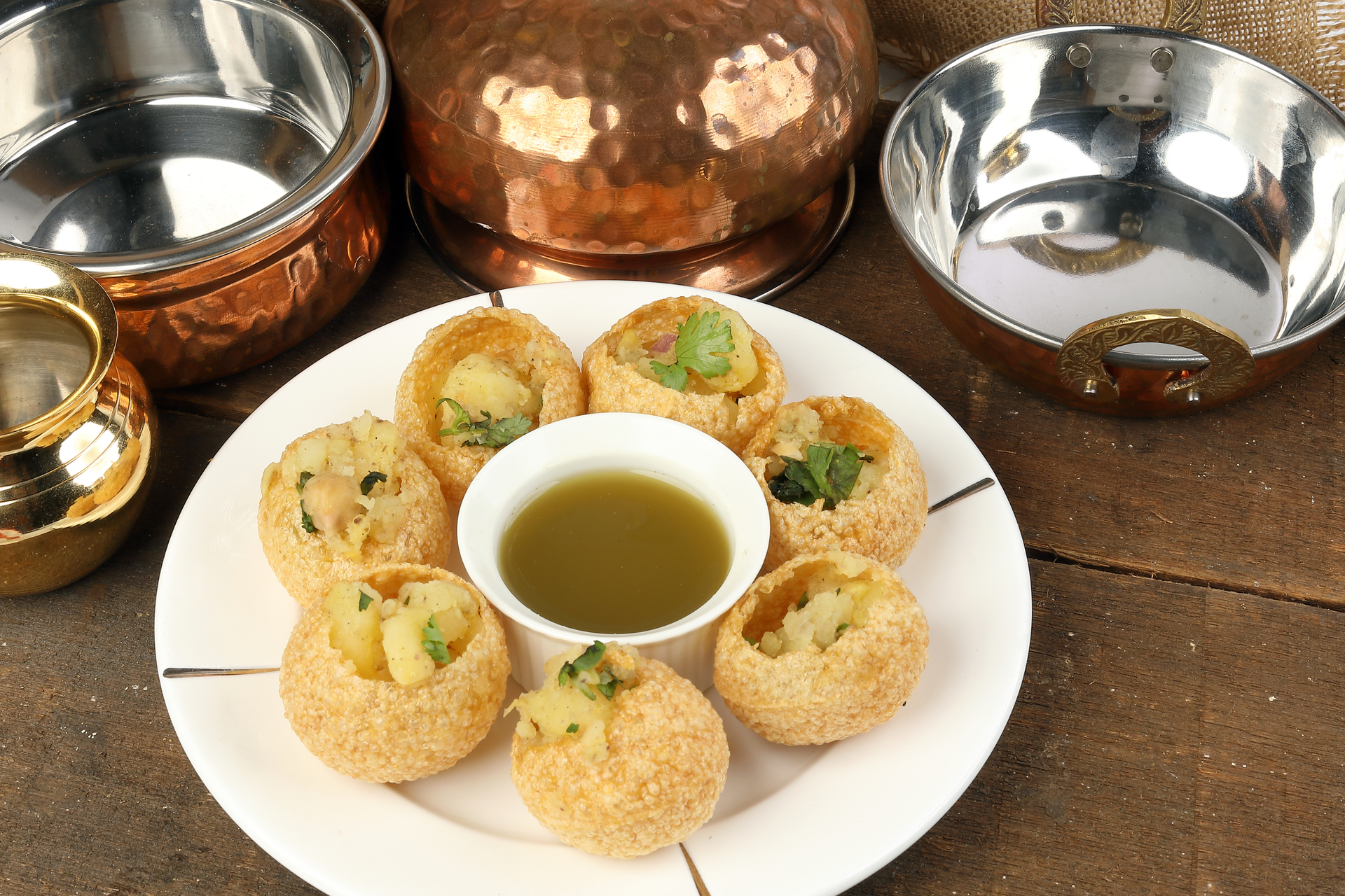 Overhead flat-lay of all ingredients for Spicy Indian Pani Puri with Tangy Tamarind Water laid out on a kitchen surface.