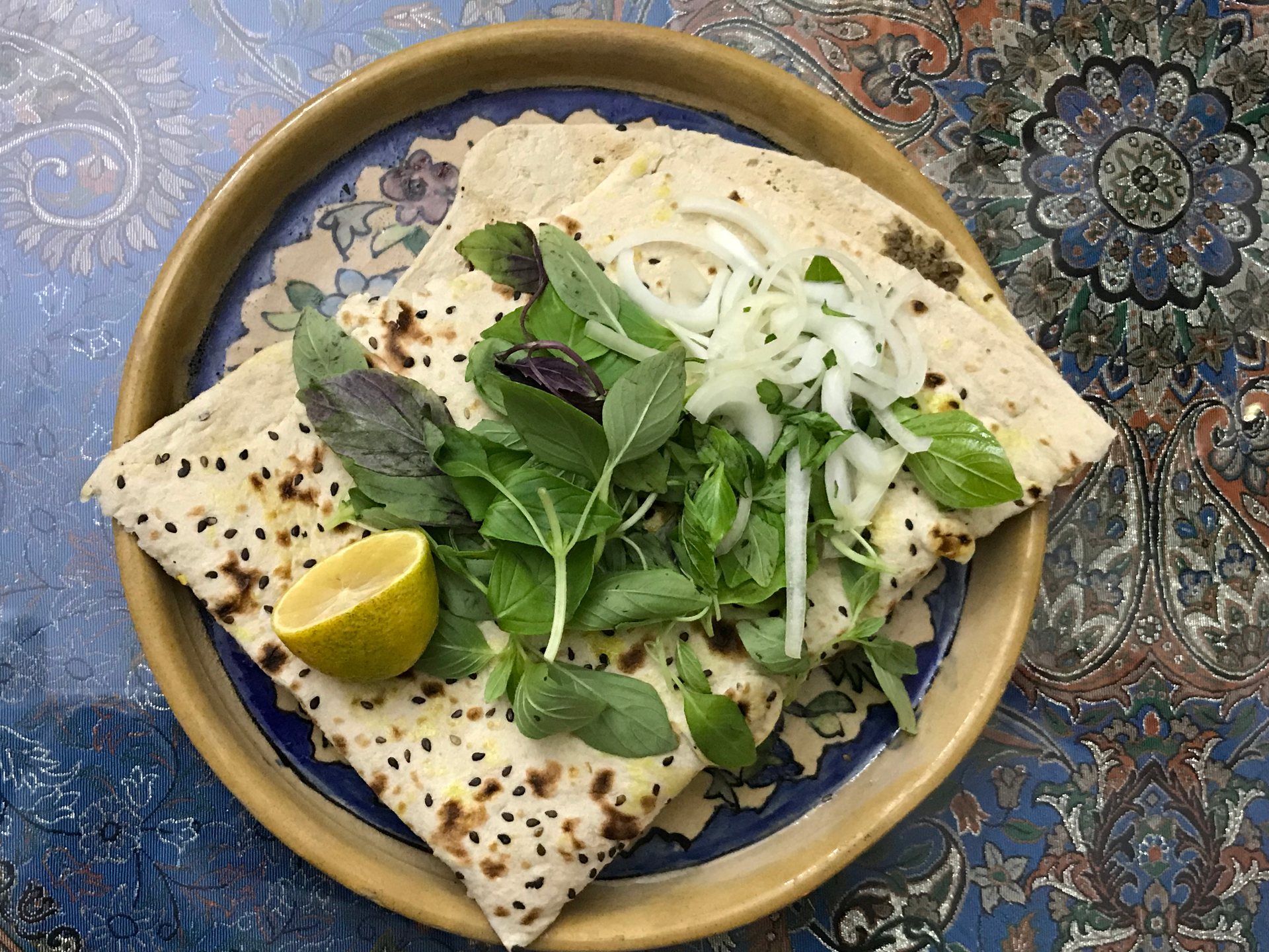 Overhead flat-lay of all ingredients for Spicy Indian Sorghum Roti with Fresh Mint and Tahini Spread laid out on a kitchen surface.