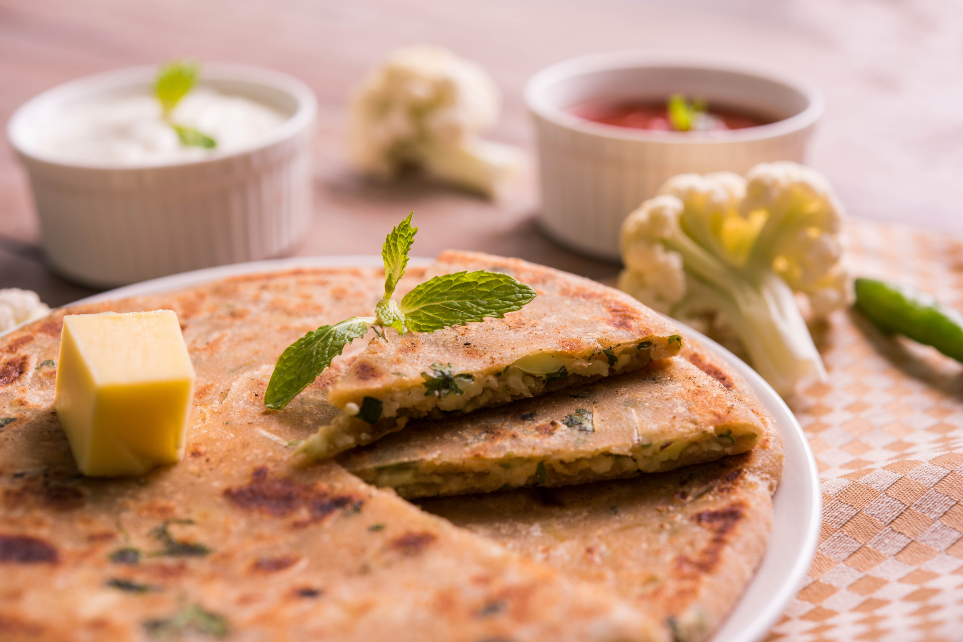 Overhead flat-lay of all ingredients for Spicy Indian Teff Dosas with Mint Chutney laid out on a kitchen surface.