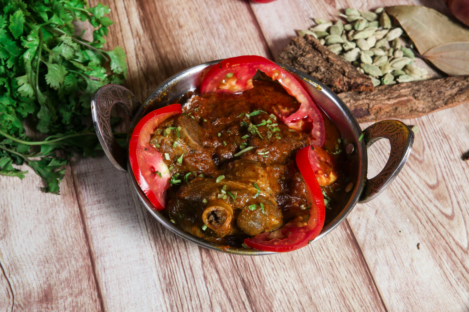 Overhead flat-lay of all ingredients for Spicy Indian Vindaloo with Tamarind and Pork laid out on a kitchen surface.