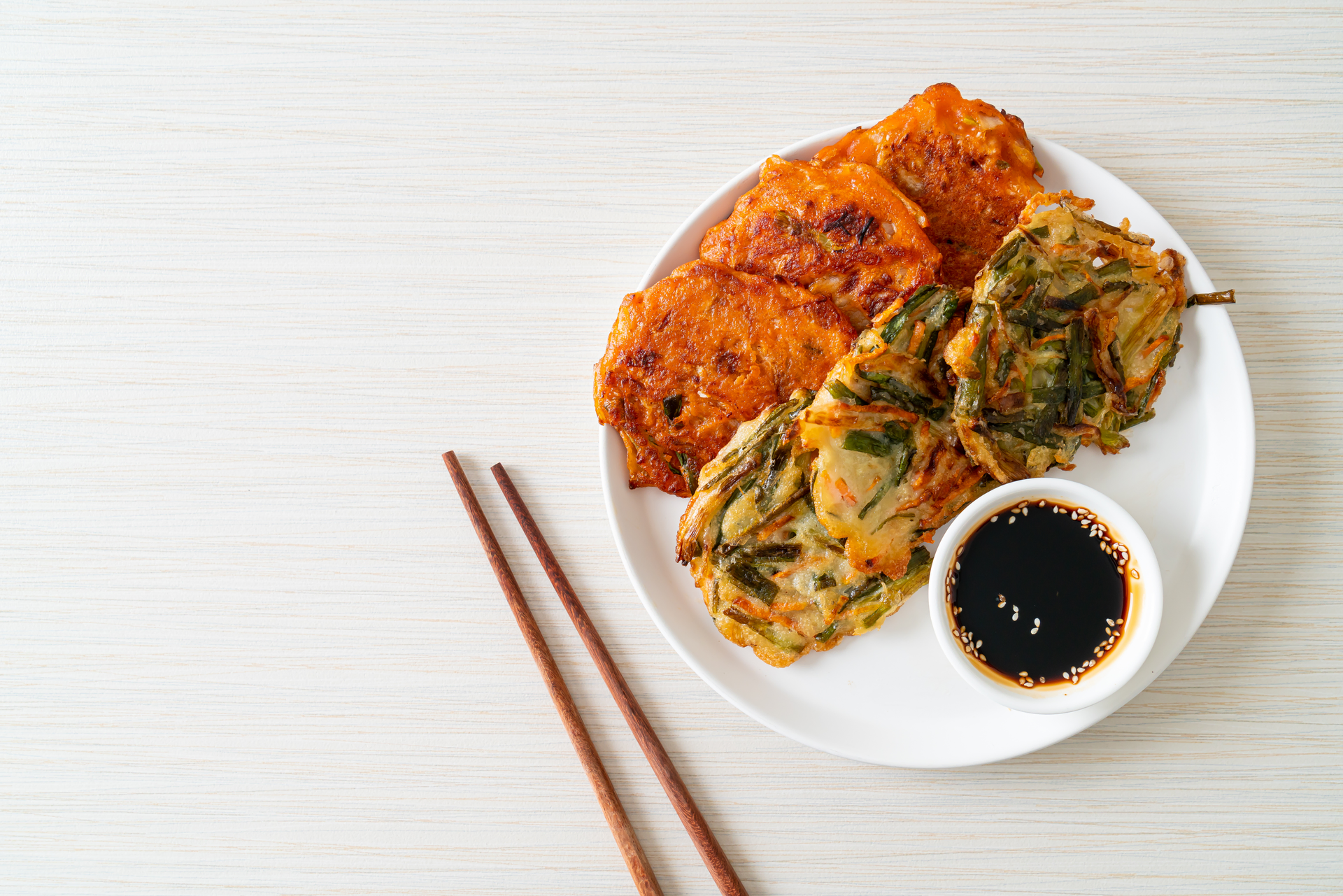 Overhead flat-lay of all ingredients for Spicy Korean Fried Kimchi with Seaweed Flakes laid out on a kitchen surface.