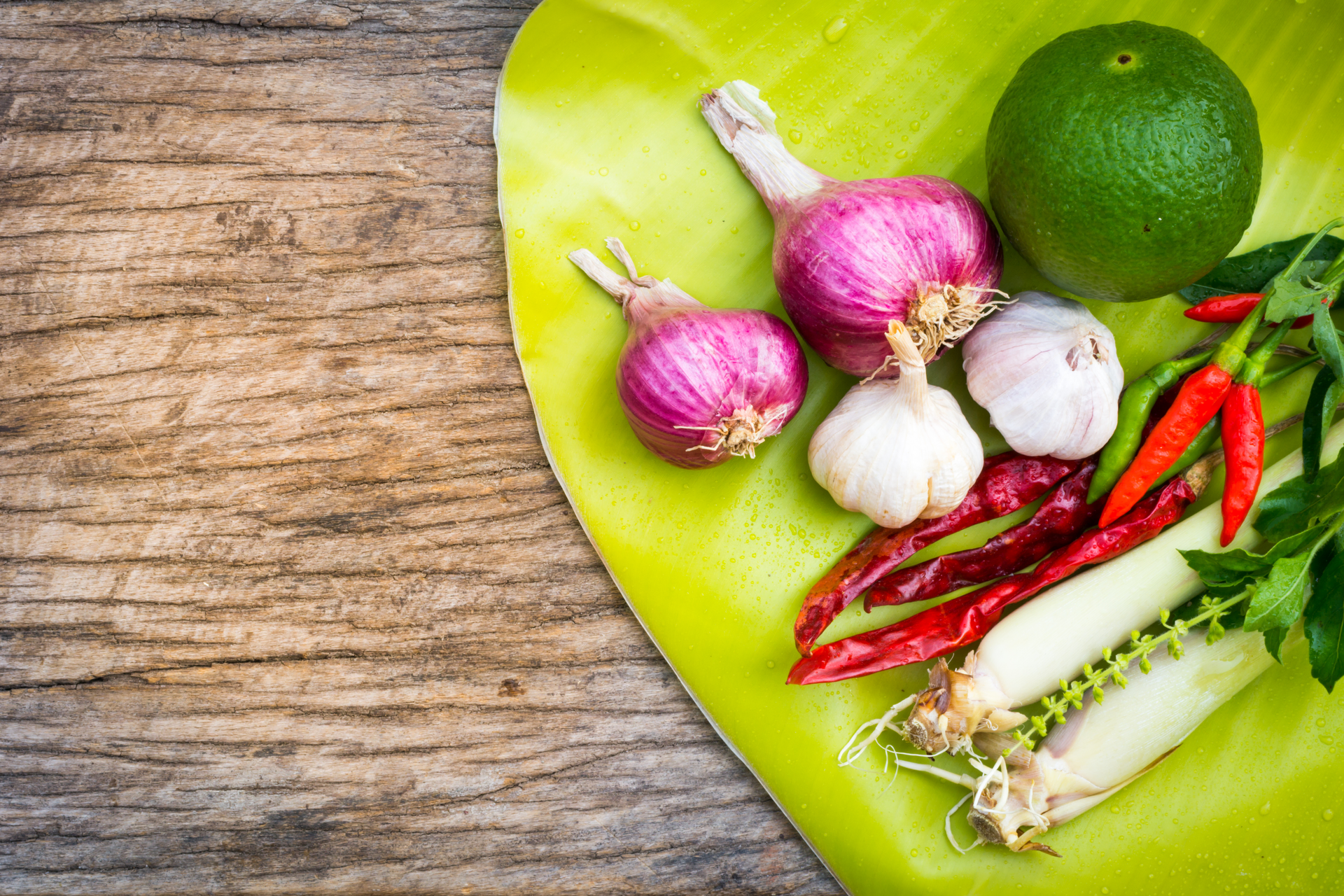 Overhead flat-lay of all ingredients for Spicy Laotian Laap with Galangal and Kaffir Lime laid out on a kitchen surface.