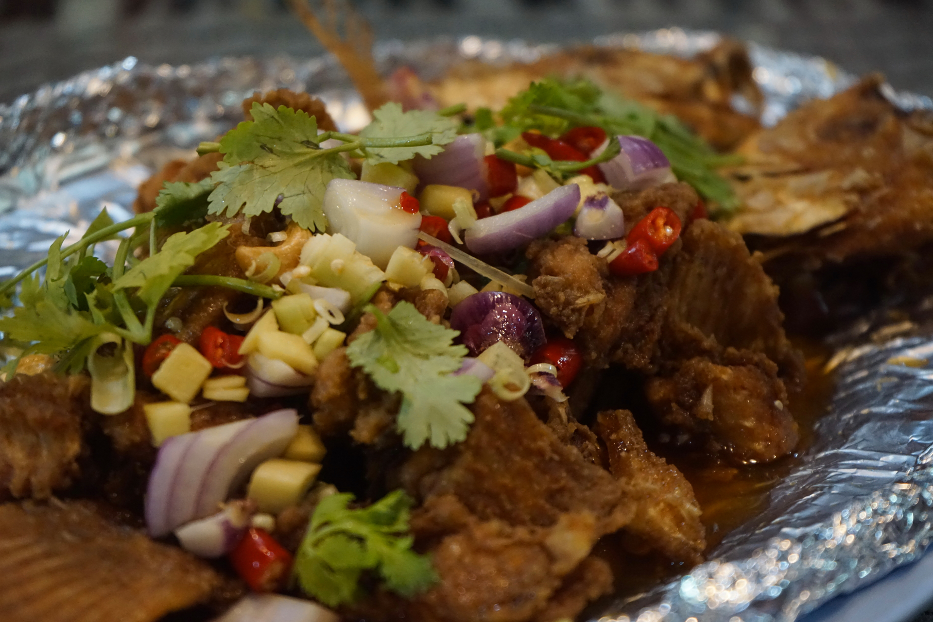 Overhead flat-lay of all ingredients for Spicy Malagasy Roasted Zebu with Tomato Ginger Salsa laid out on a kitchen surface.