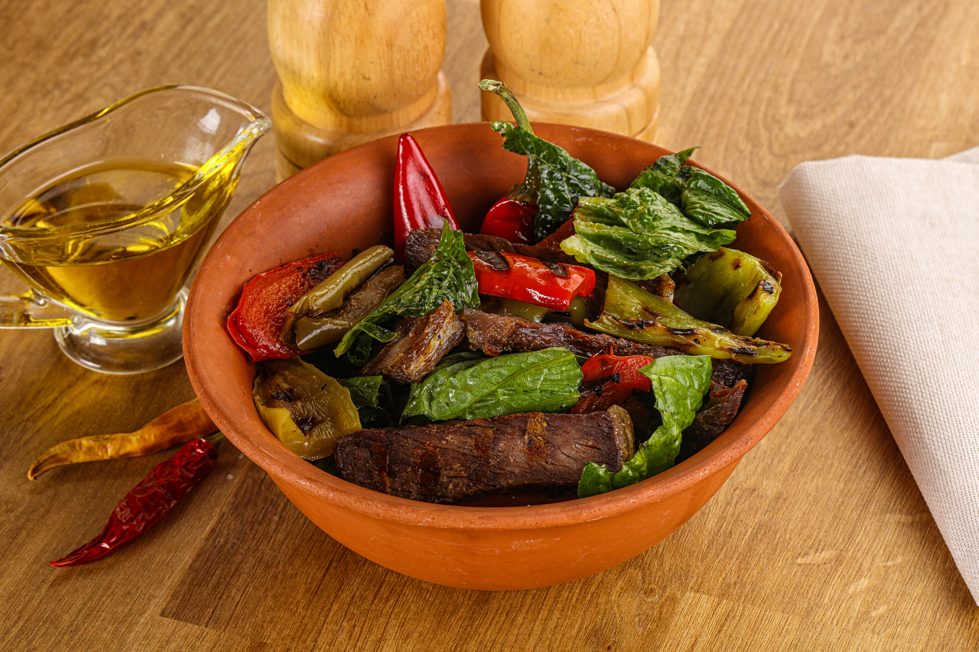 Overhead flat-lay of all ingredients for Spicy Malagasy Romazava with Beef and Greens laid out on a kitchen surface.