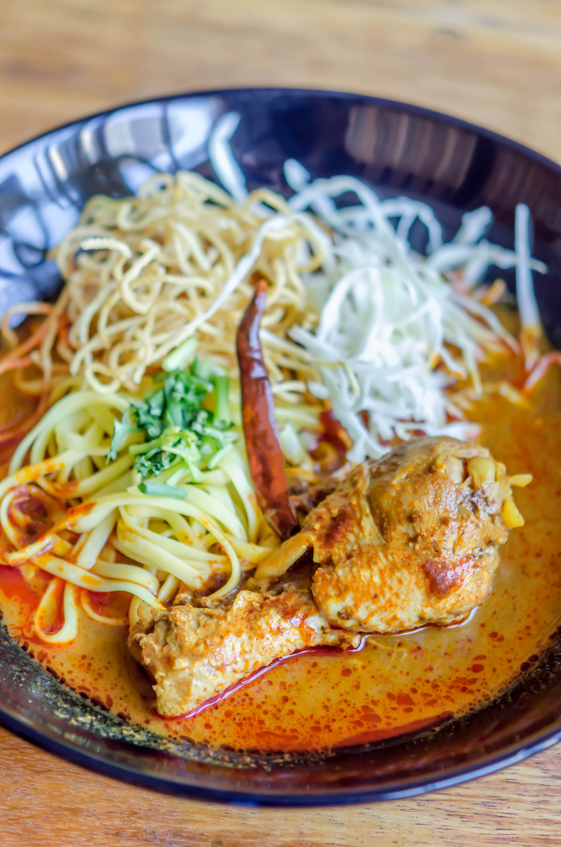 Spicy Malaysian Asam Laksa with Tamarind Fish Broth — Main Course served and photographed from above